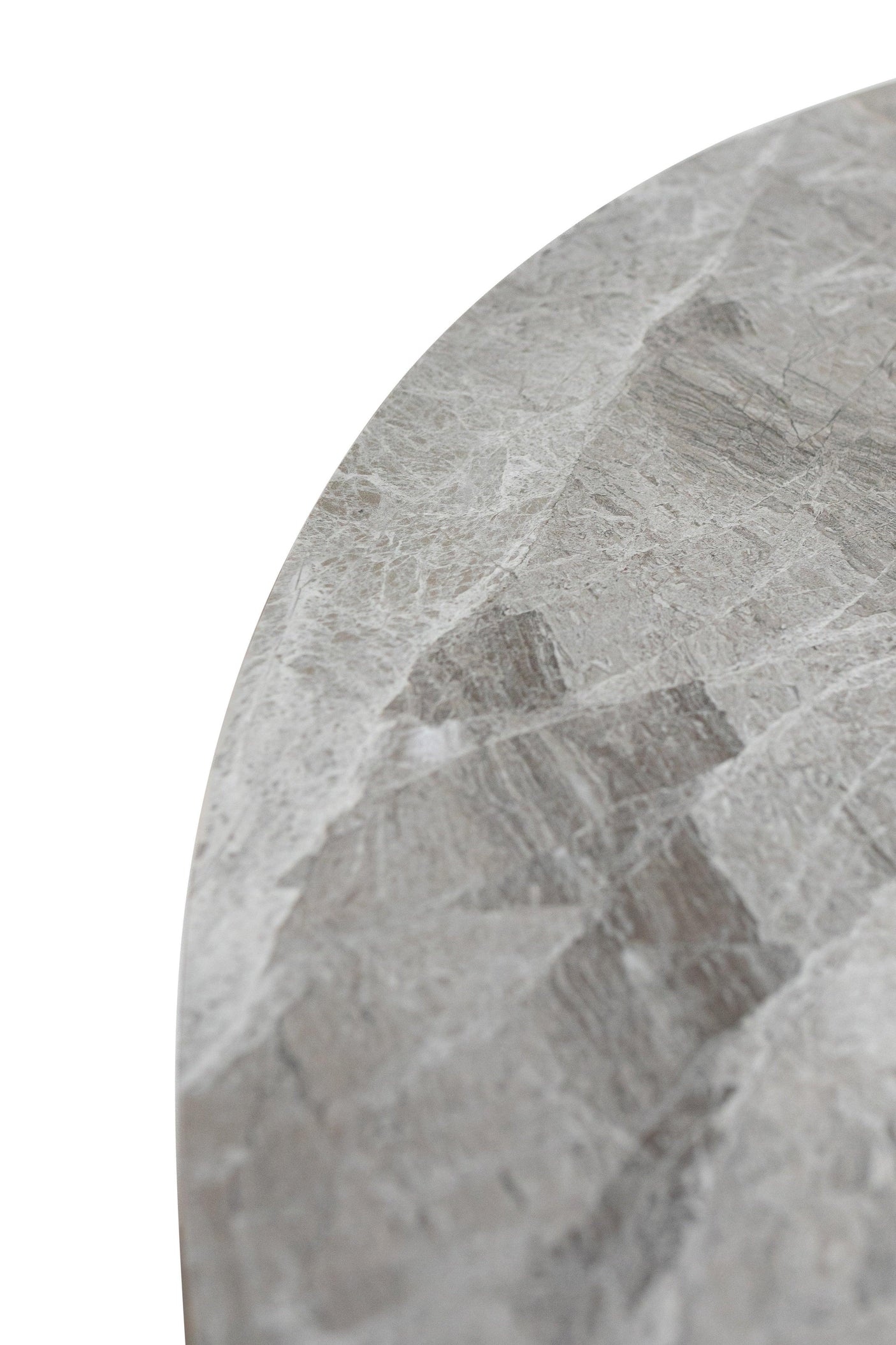 Close up of round marble table top with grey veining and polished stone finish