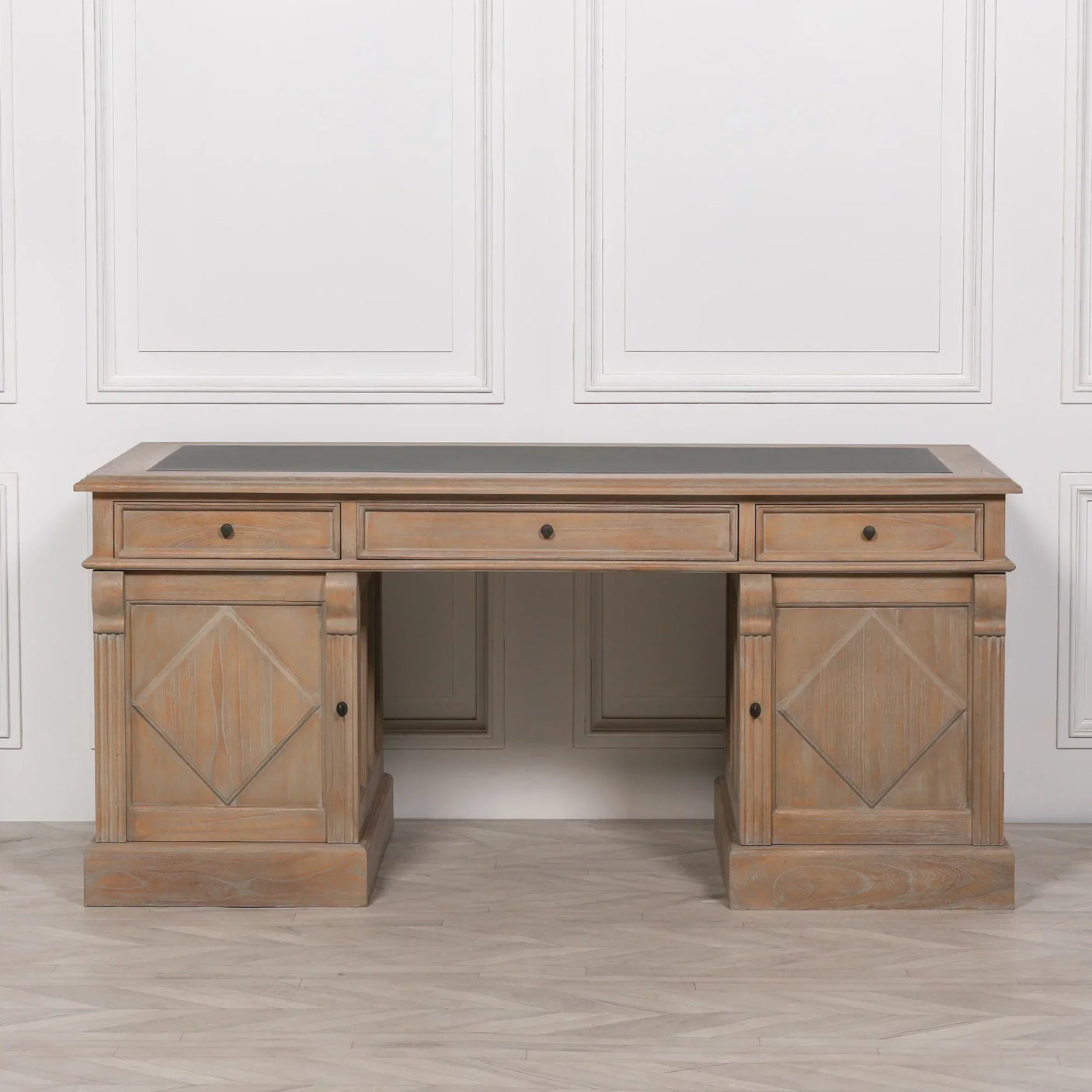 Oak wood office desk with three drawers and diamond panel detailing, shown front view