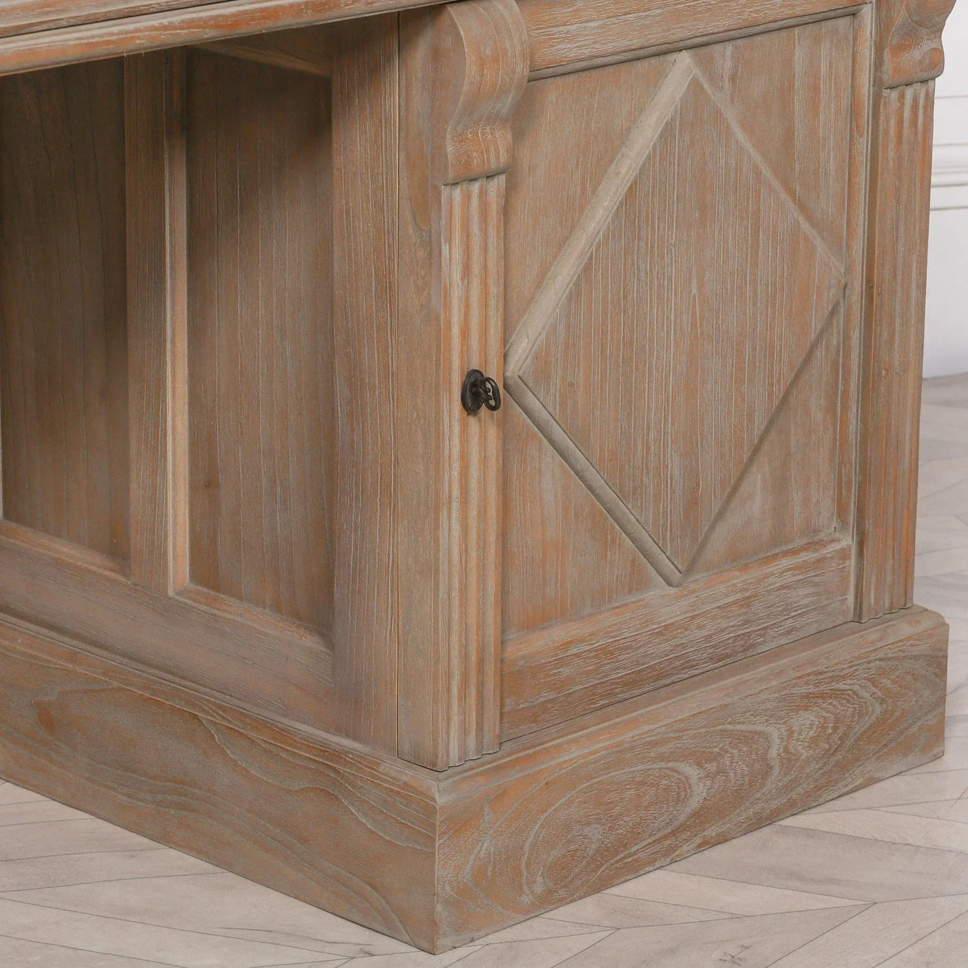 Rustic wood sideboard cabinet with diamond panel detail and metal handle, close-up view