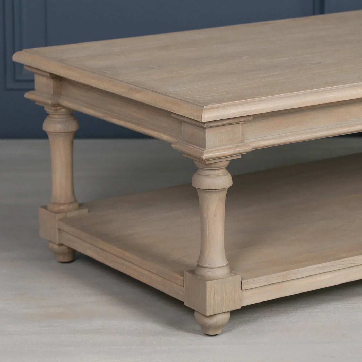 Oak coffee table with turned legs and lower shelf, light wood finish, side perspective