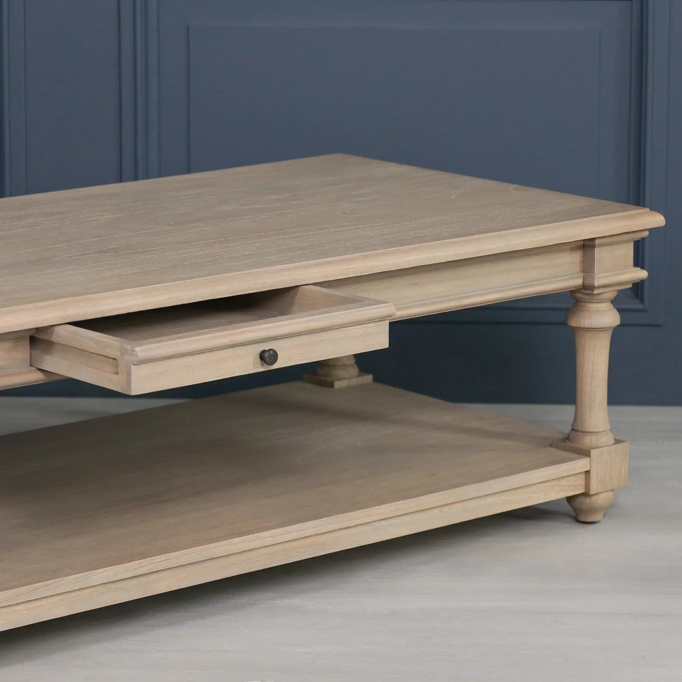 Oak coffee table with lower shelf and single drawer, turned legs, light wood finish