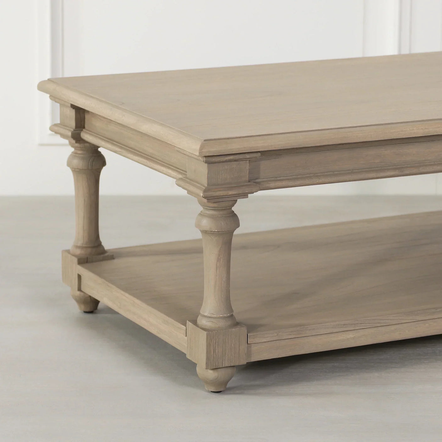 Oak wood coffee table with turned legs and lower storage shelf, corner perspective view