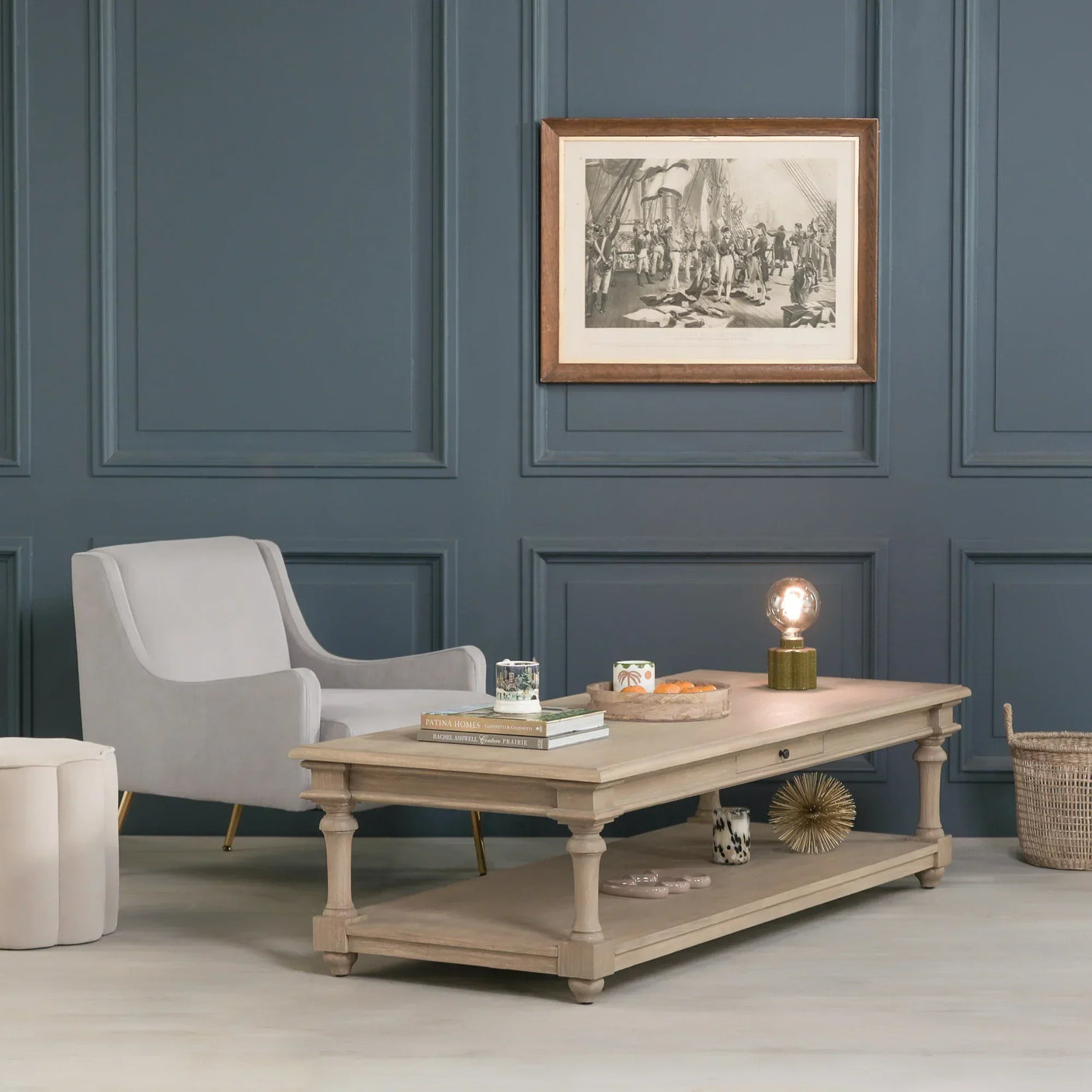 Oak coffee table with lower shelf styled in modern living room with grey armchair