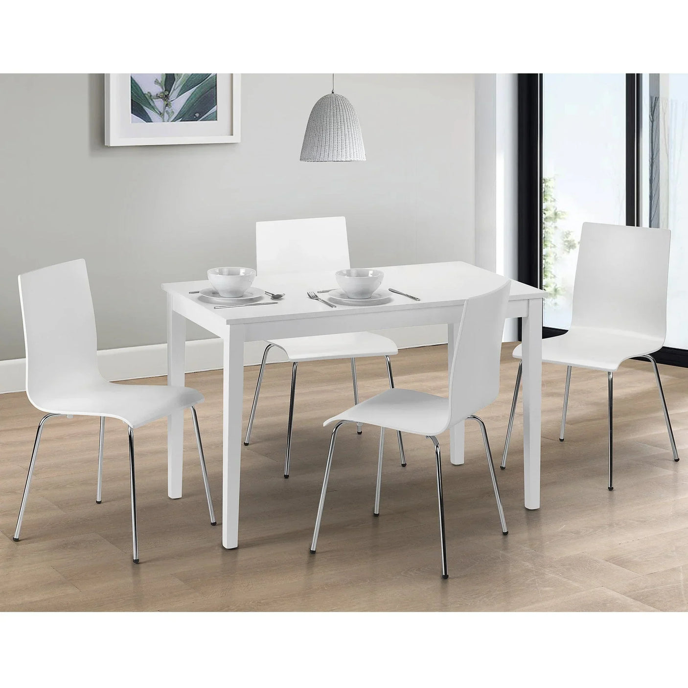 White dining set with four chairs and table on wood floor in modern dining room