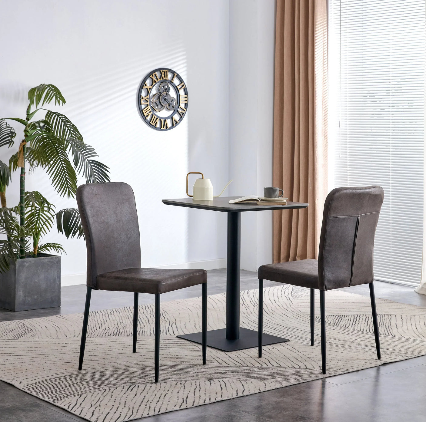 Square grey dining table and two charcoal grey chairs in modern dining room