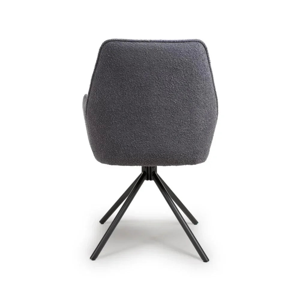 Grey fabric accent chair with black metal legs shown from rear view