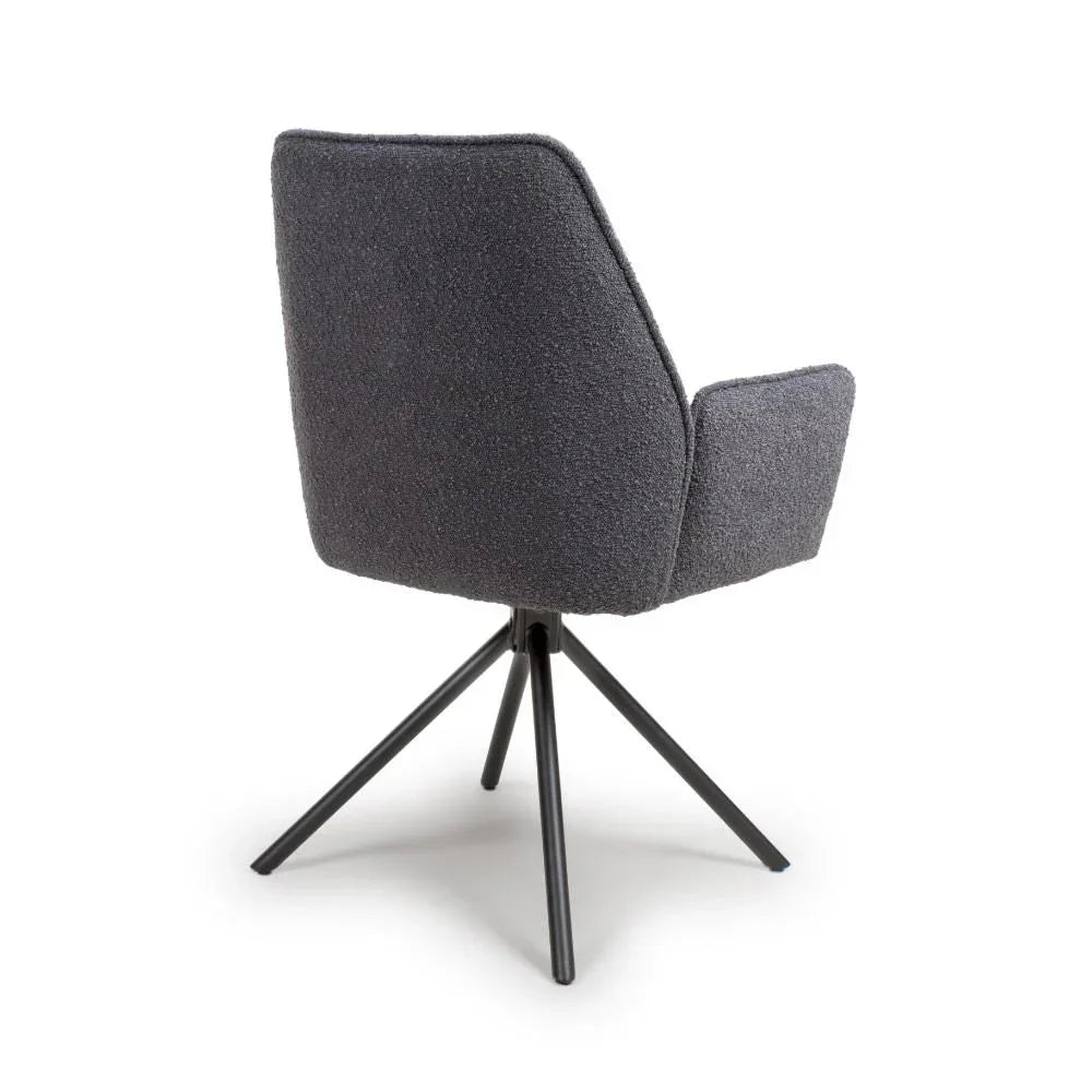 dark grey dining chair with fabric upholstery and angled metal legs, rear view