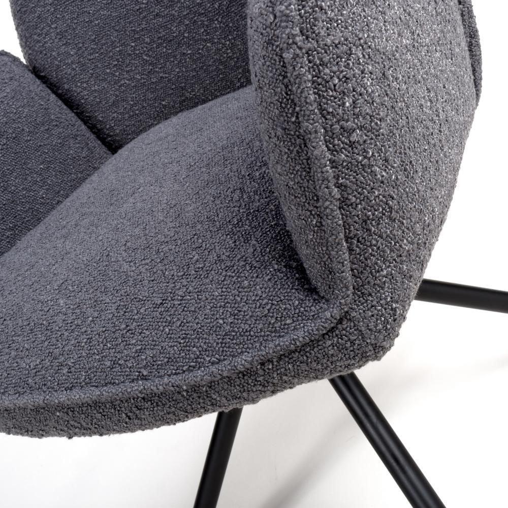 Close-up of grey boucle dining chair upholstery and black metal legs