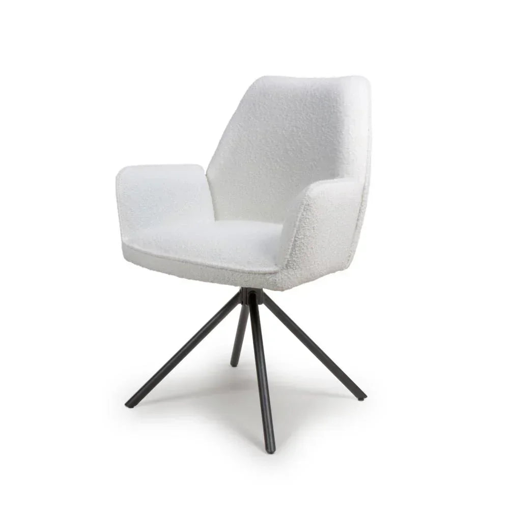 White fabric dining chair with armrests and black metal legs on white background