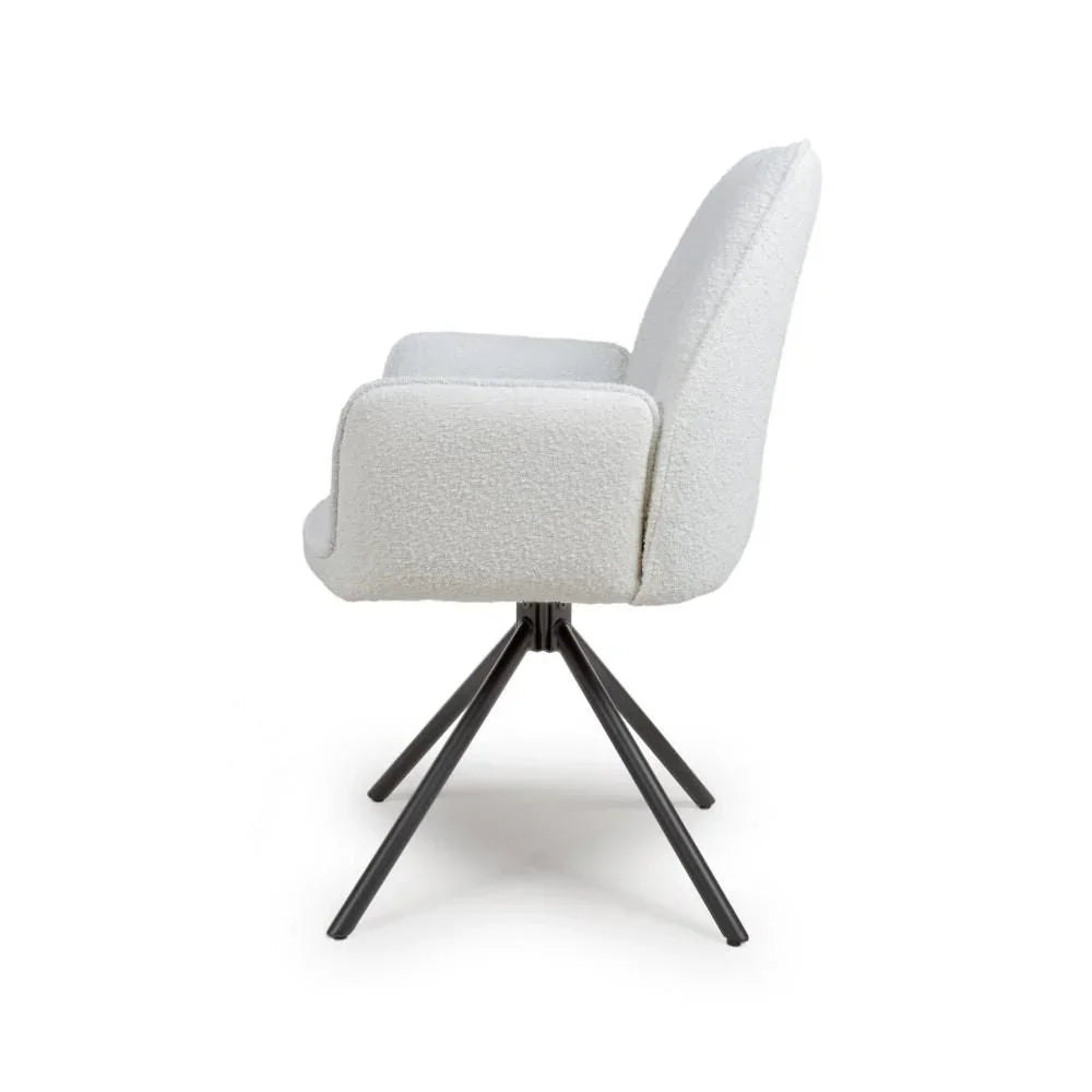 Side view of a white boucle dining chair with black metal legs
