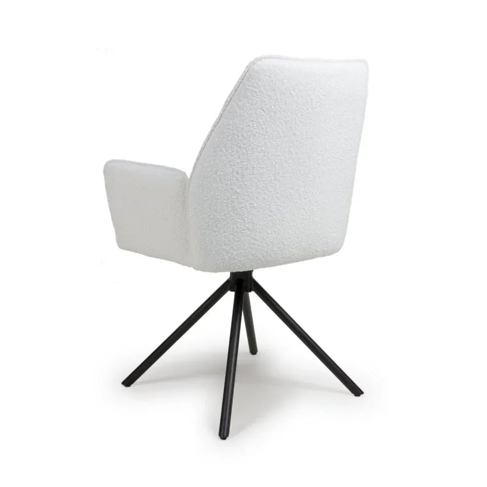 White boucle accent chair with black metal legs, rear view showing armrests and angled base