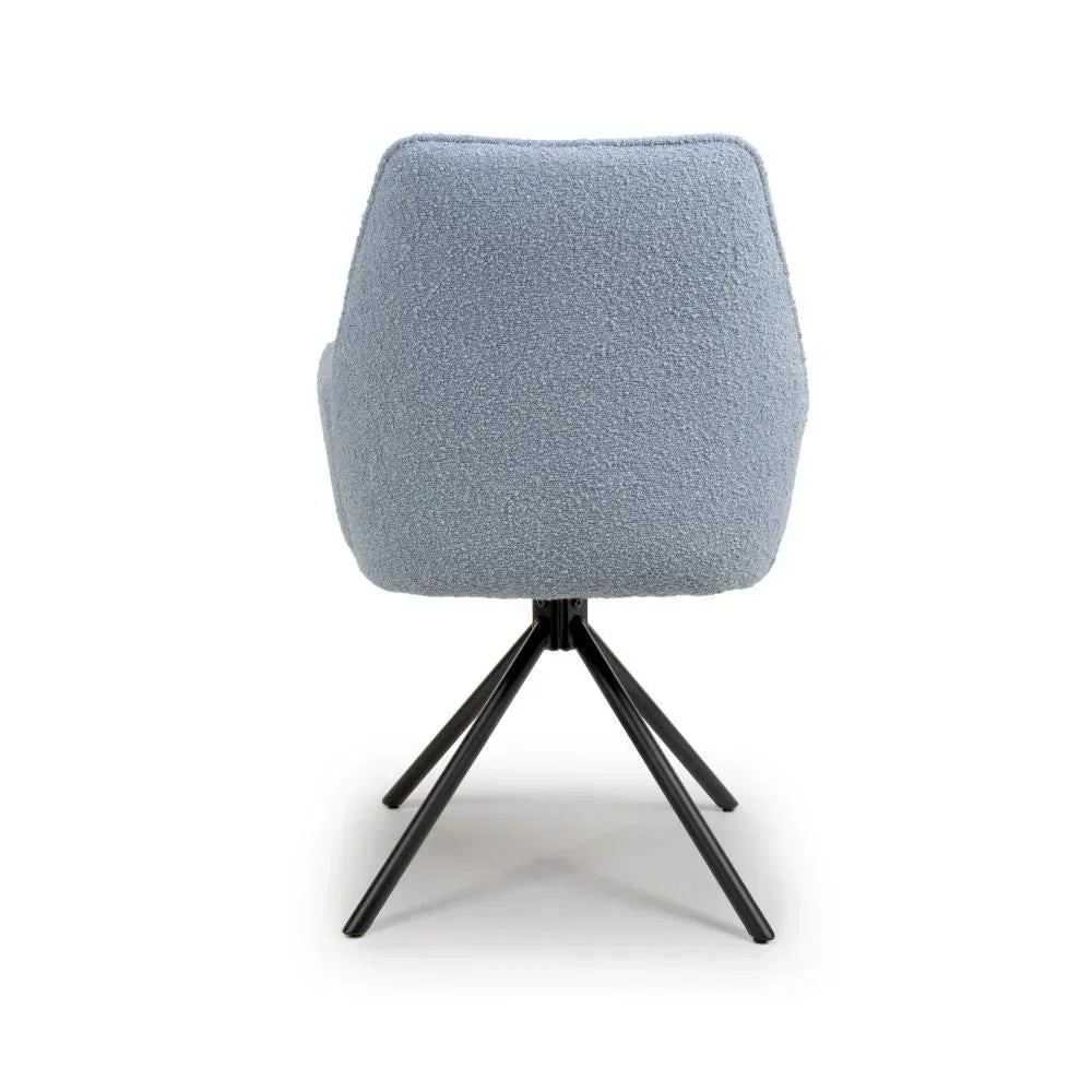 Light blue boucle dining chair with black metal legs shown from the back