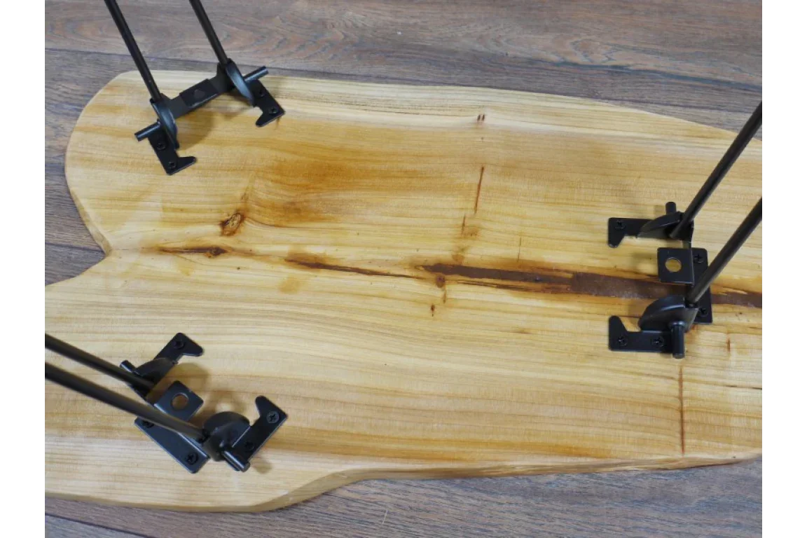 Live edge wood coffee table with black metal hairpin legs on wood floor