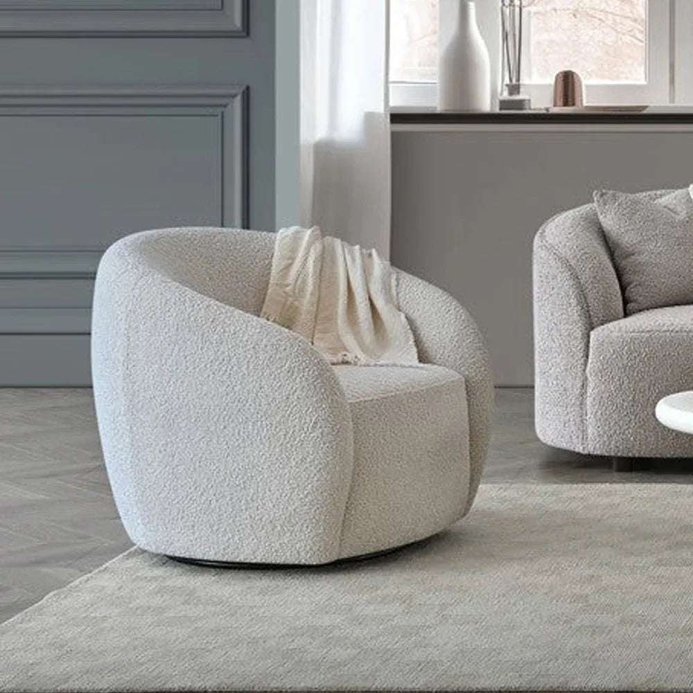 Modern boucle accent chair in cream fabric with curved backrest in living room