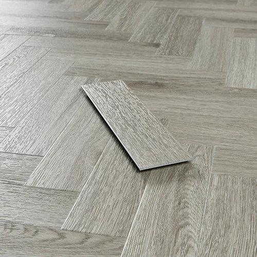 Urban grey wood effect vinyl flooring in herringbone pattern, single plank displayed