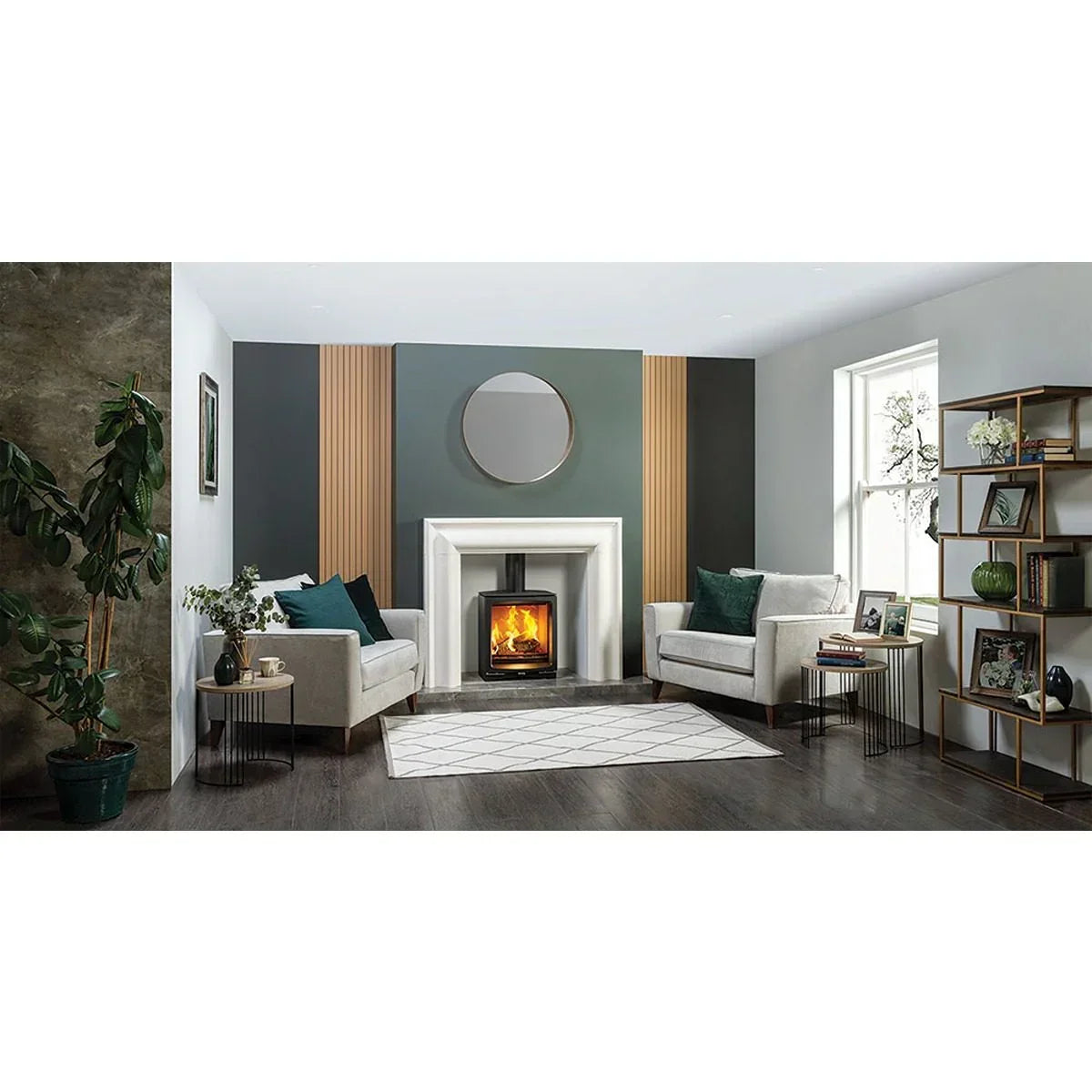 Modern living room with two cream armchairs, wood burner fireplace and geometric rug