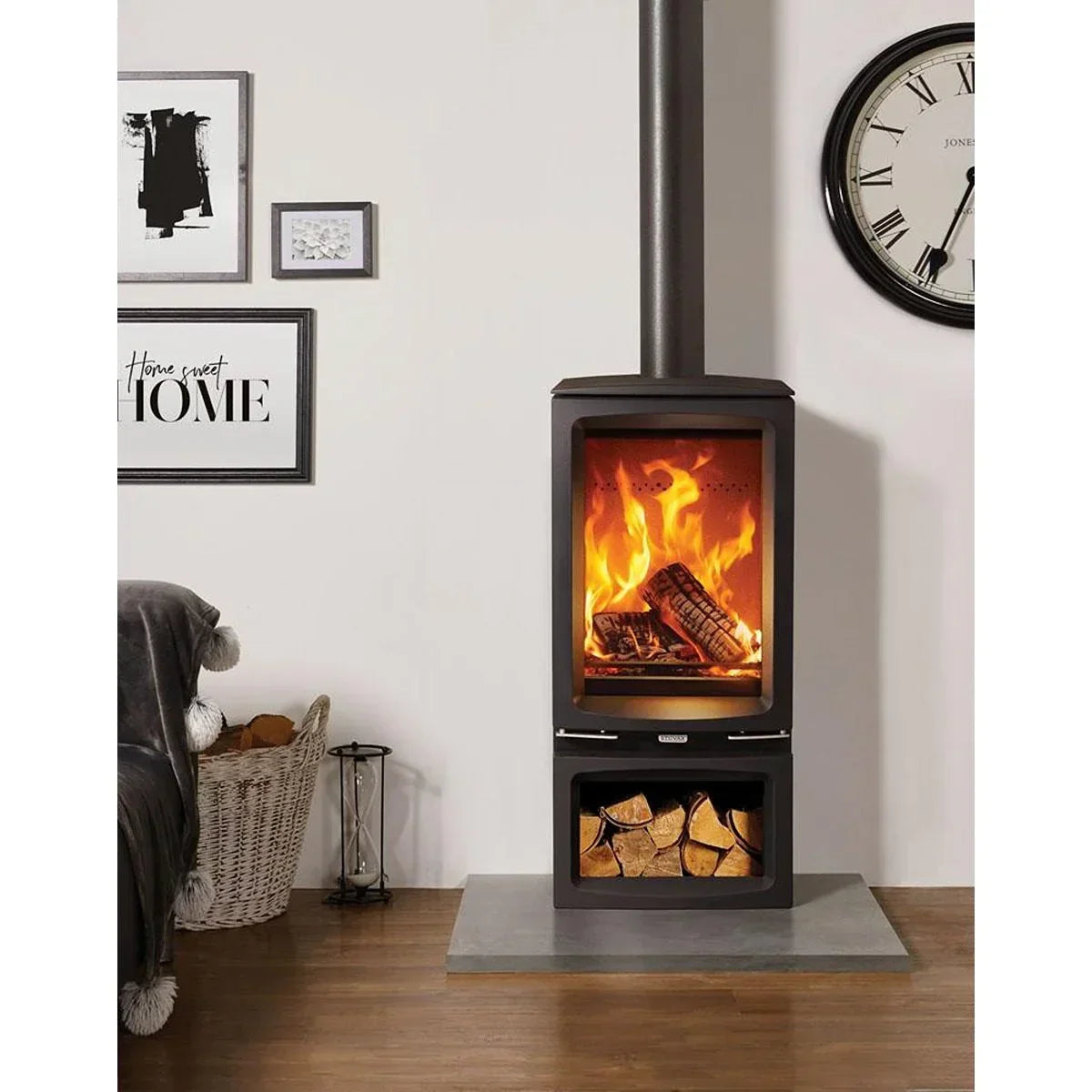 Black freestanding wood burning stove with log storage in cosy living room setting