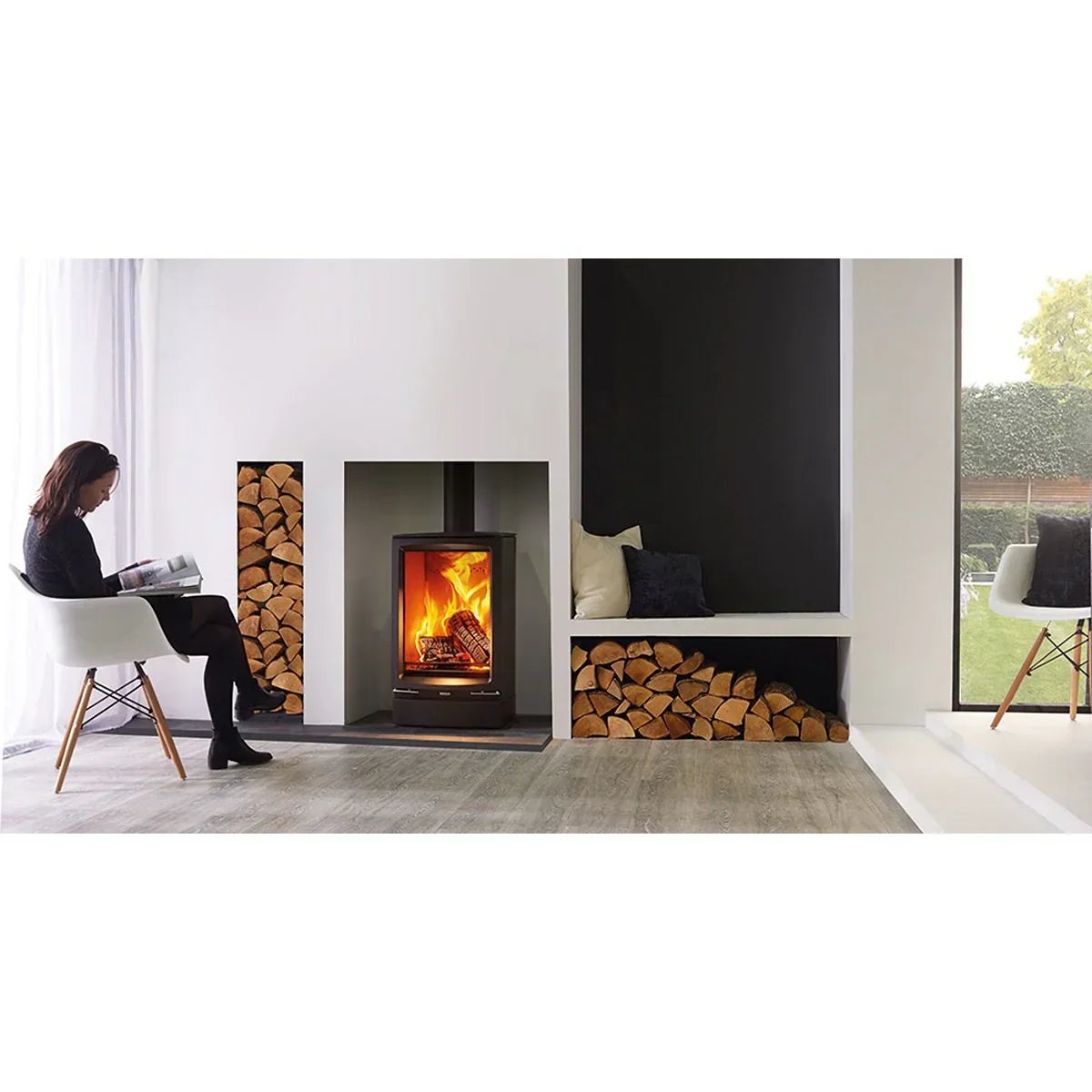 Modern living room with wood burning stove, built-in log storage, and window seating area