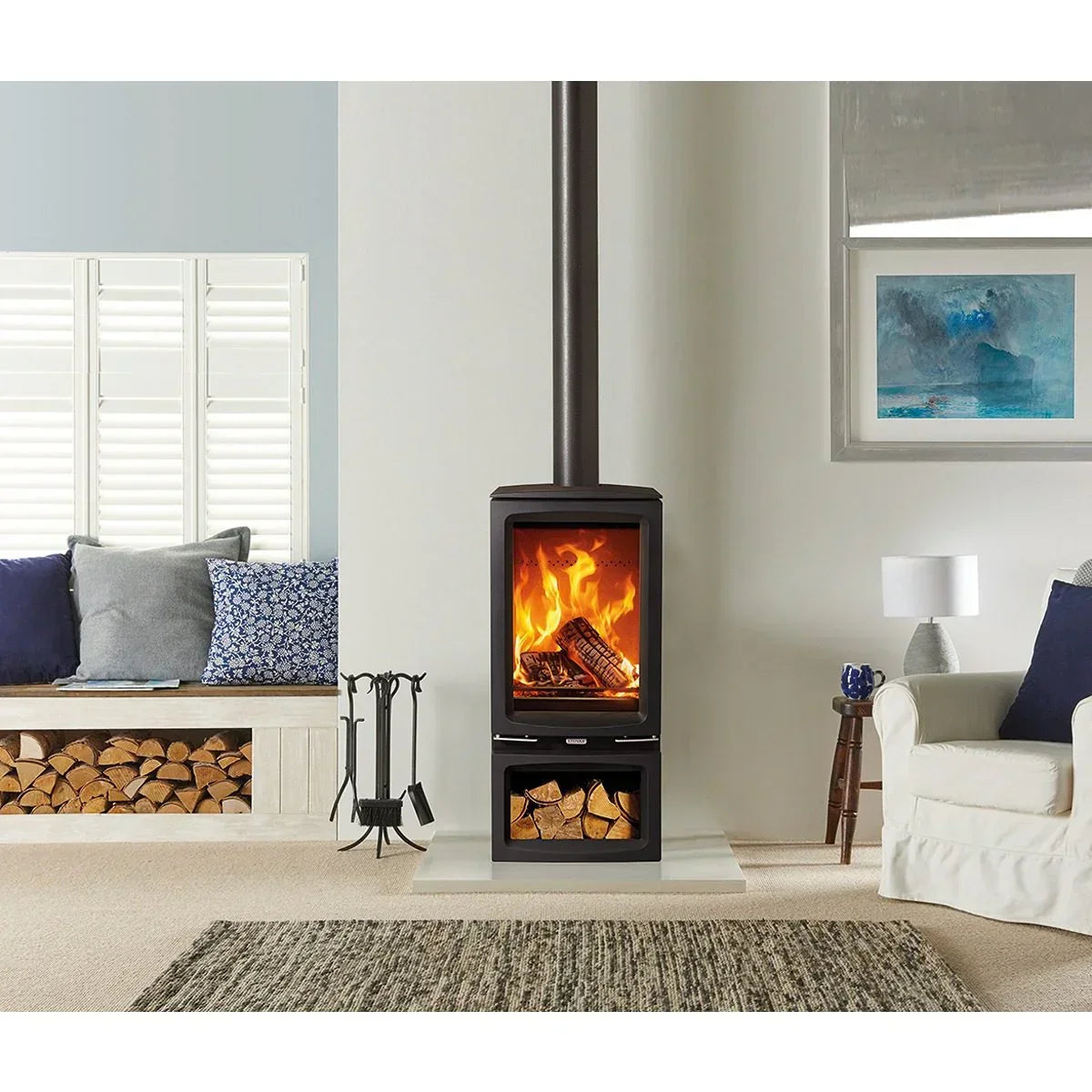 Modern wood burning stove in living room with log storage and firewood stacked nearby