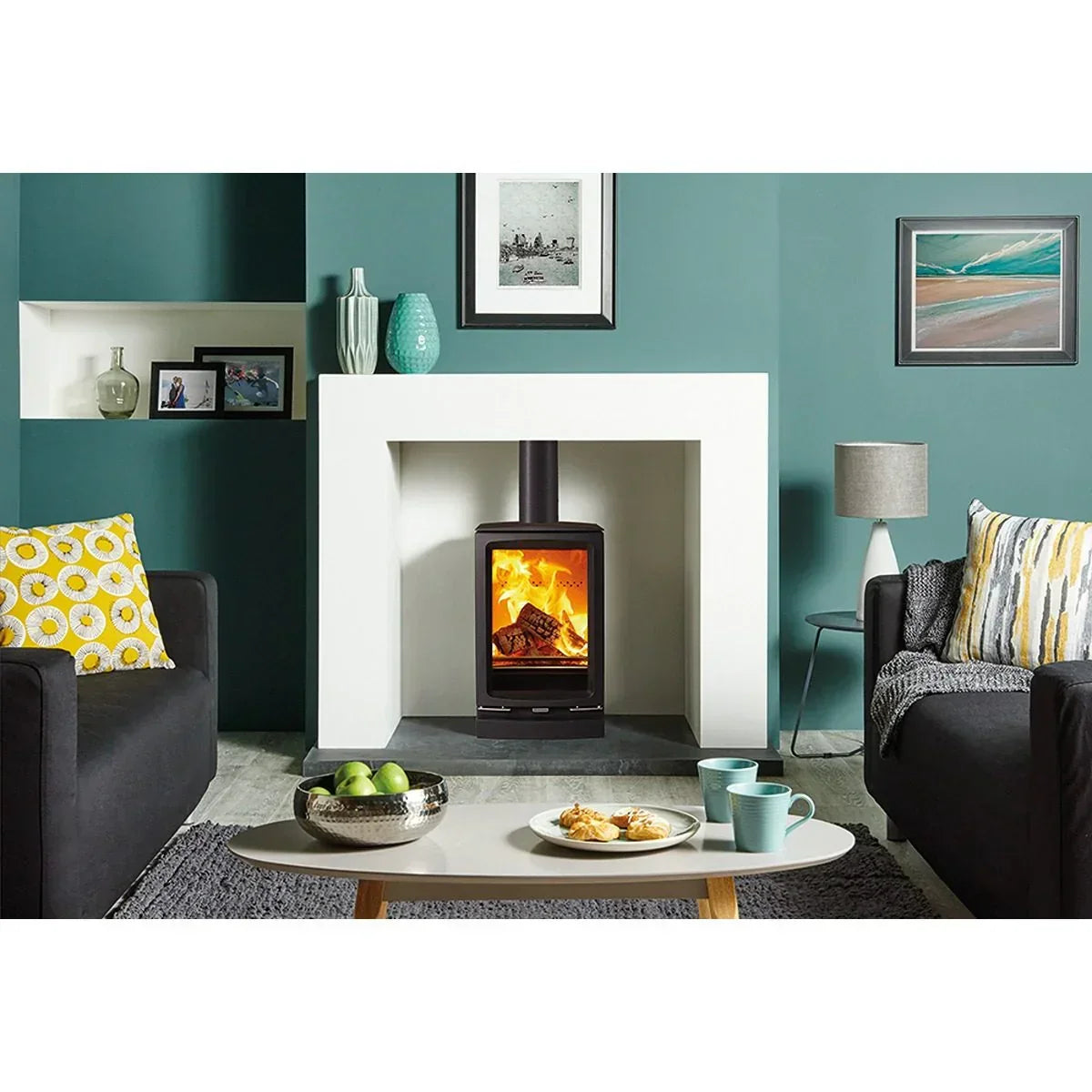 Modern living room with wood burning stove, black sofas, and contemporary decor