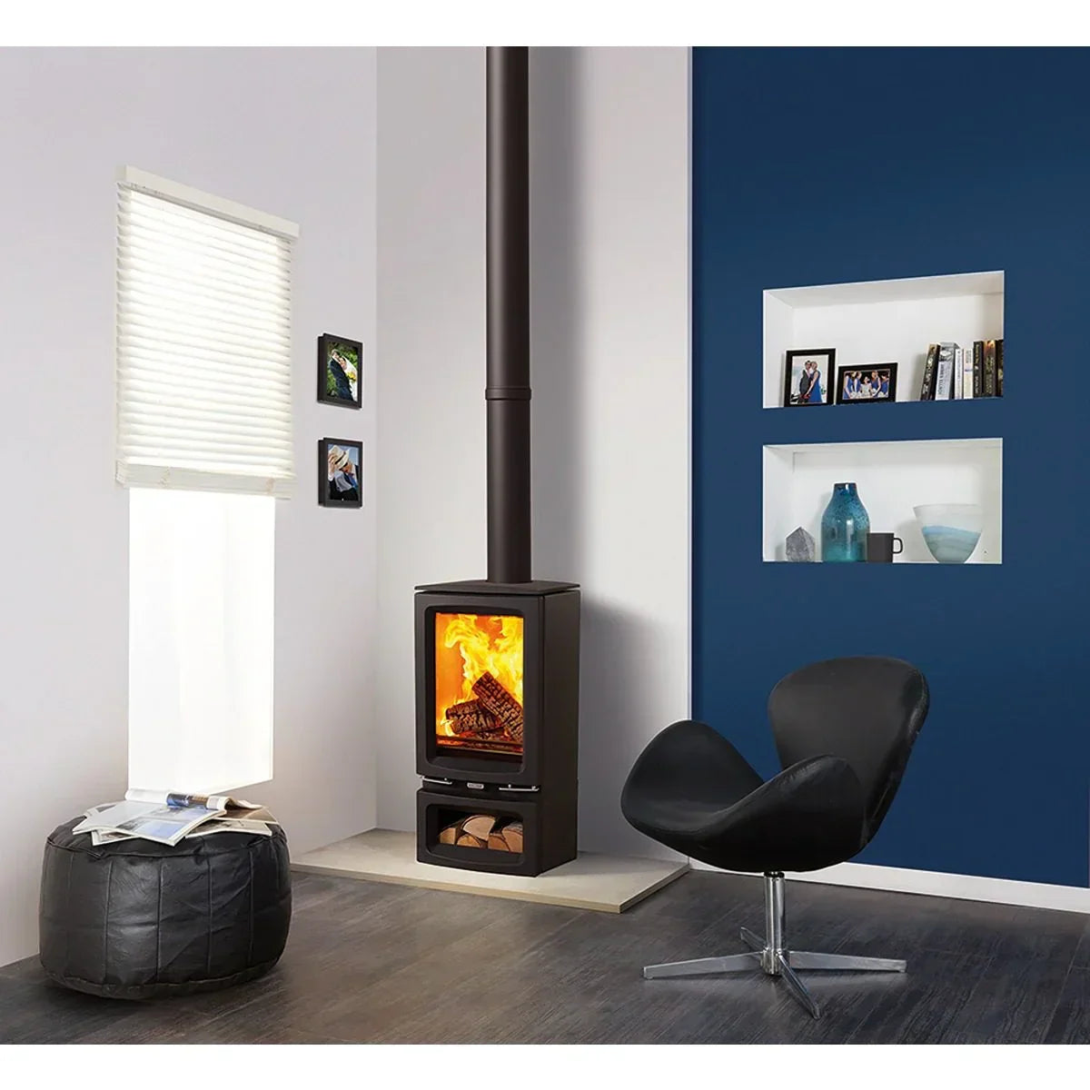 Modern wood burning stove with fire, black swivel chair and blue accent wall in living room