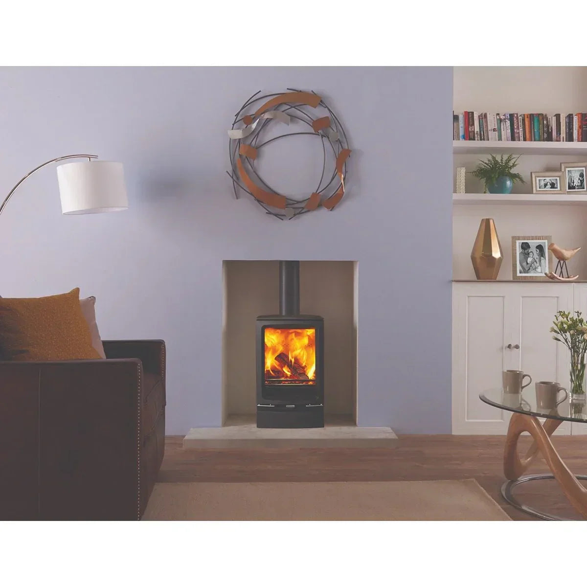 Modern wood burning stove with glass door in cosy living room setting
