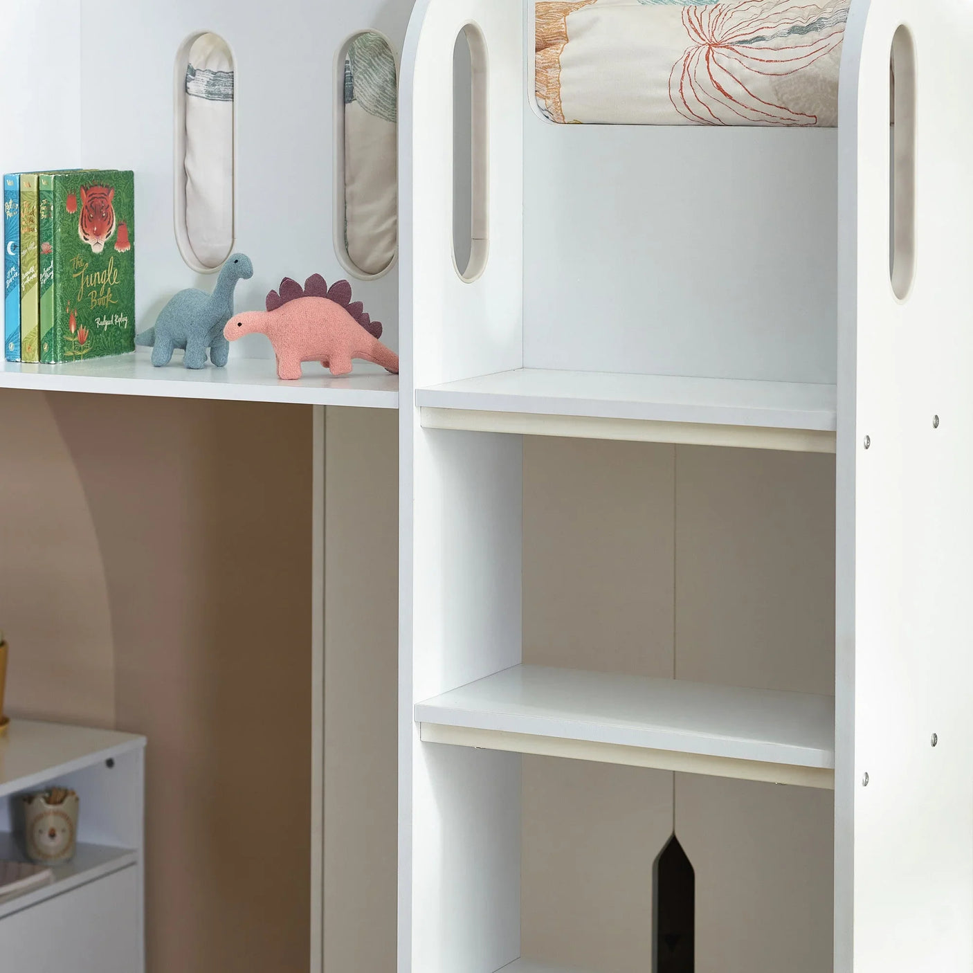 White kids storage shelves with books, dinosaur toys and open compartments