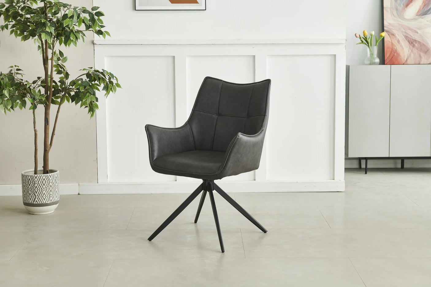 Black swivel accent chair with armrests and metal legs in modern living room setting