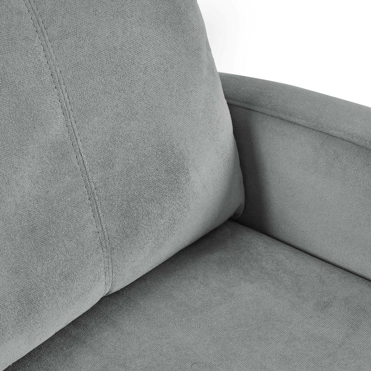 Closeup of grey fabric armchair with soft cushioned seat and backrest