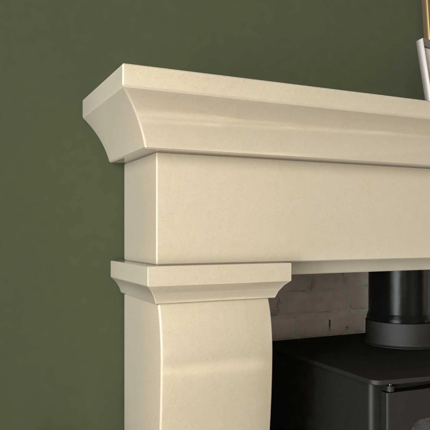 Cream stone fireplace mantle with smooth surface and decorative molding, close-up view