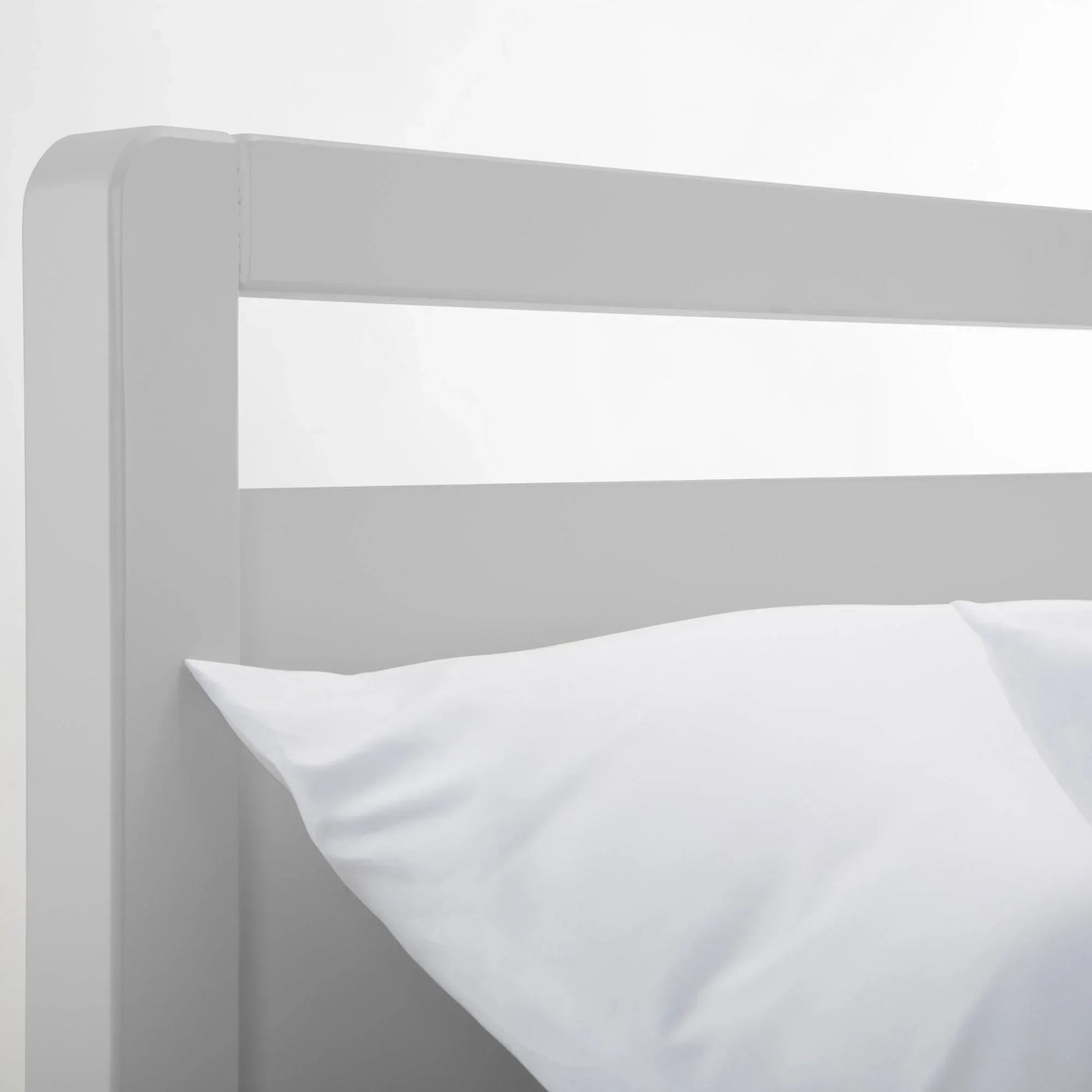 Dove grey bed headboard detail with white pillow, modern minimalist bed frame design