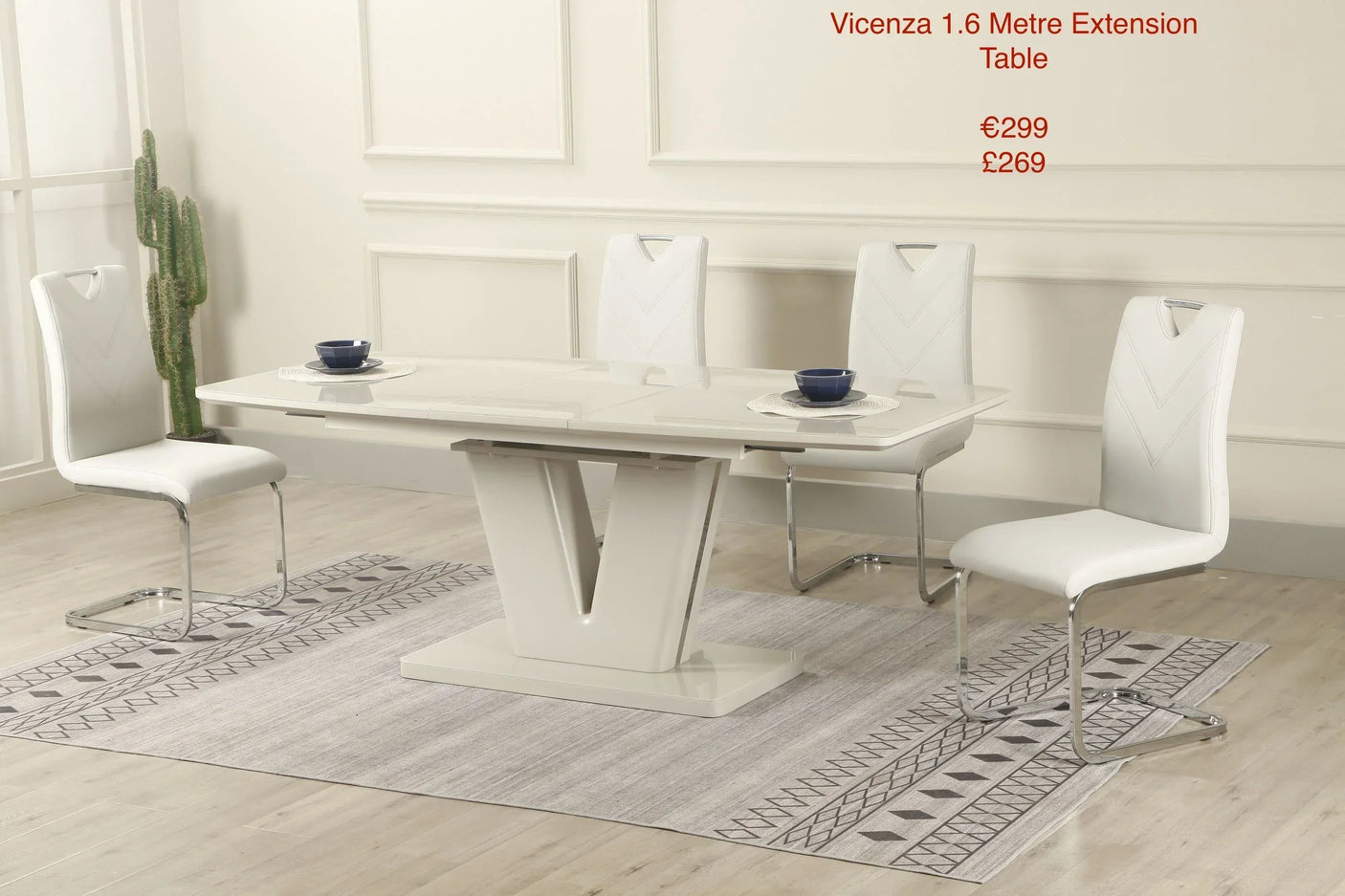 Vicenza extension dining table with four white chairs on patterned rug in modern room
