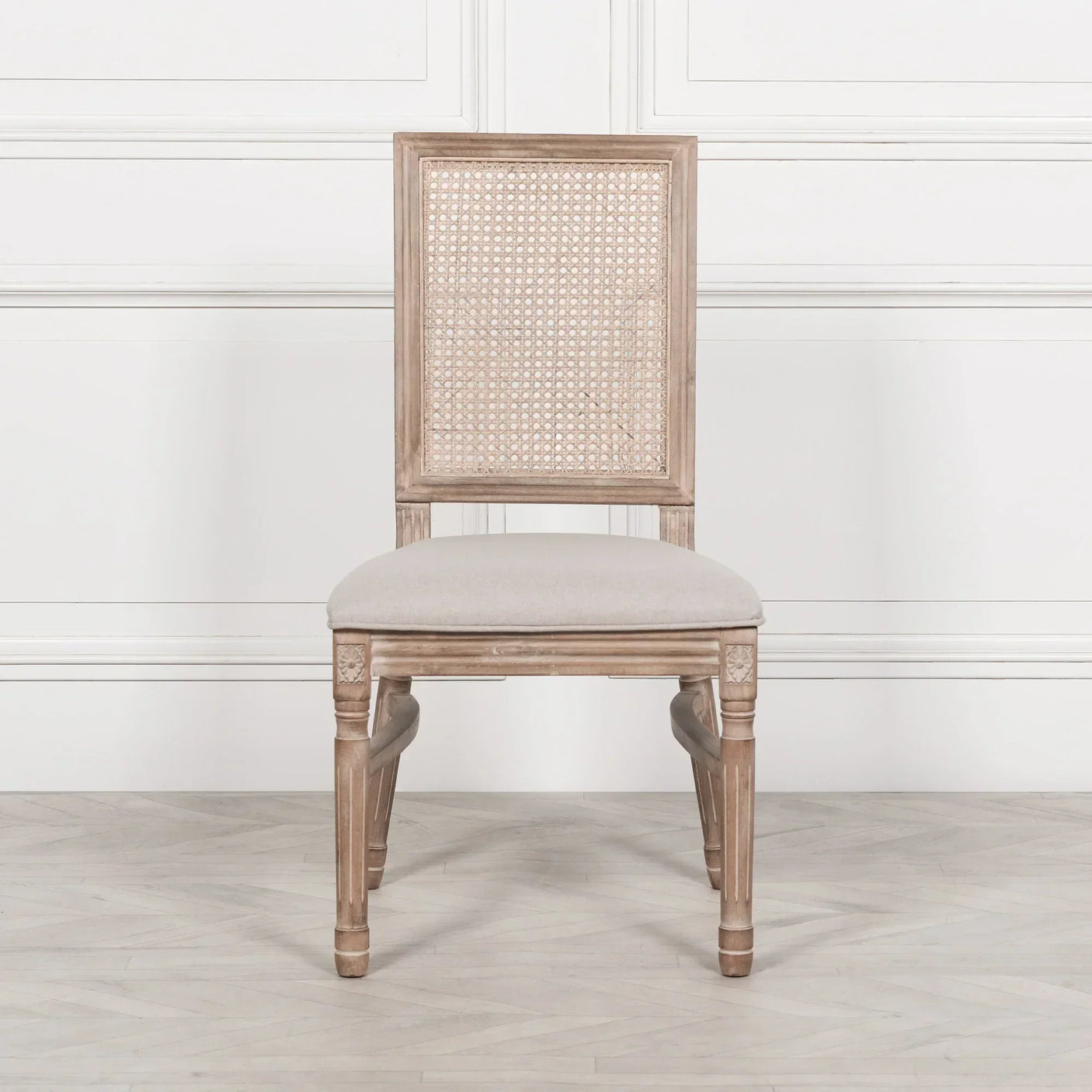 Wooden dining chair with cane backrest and beige upholstered seat, front view