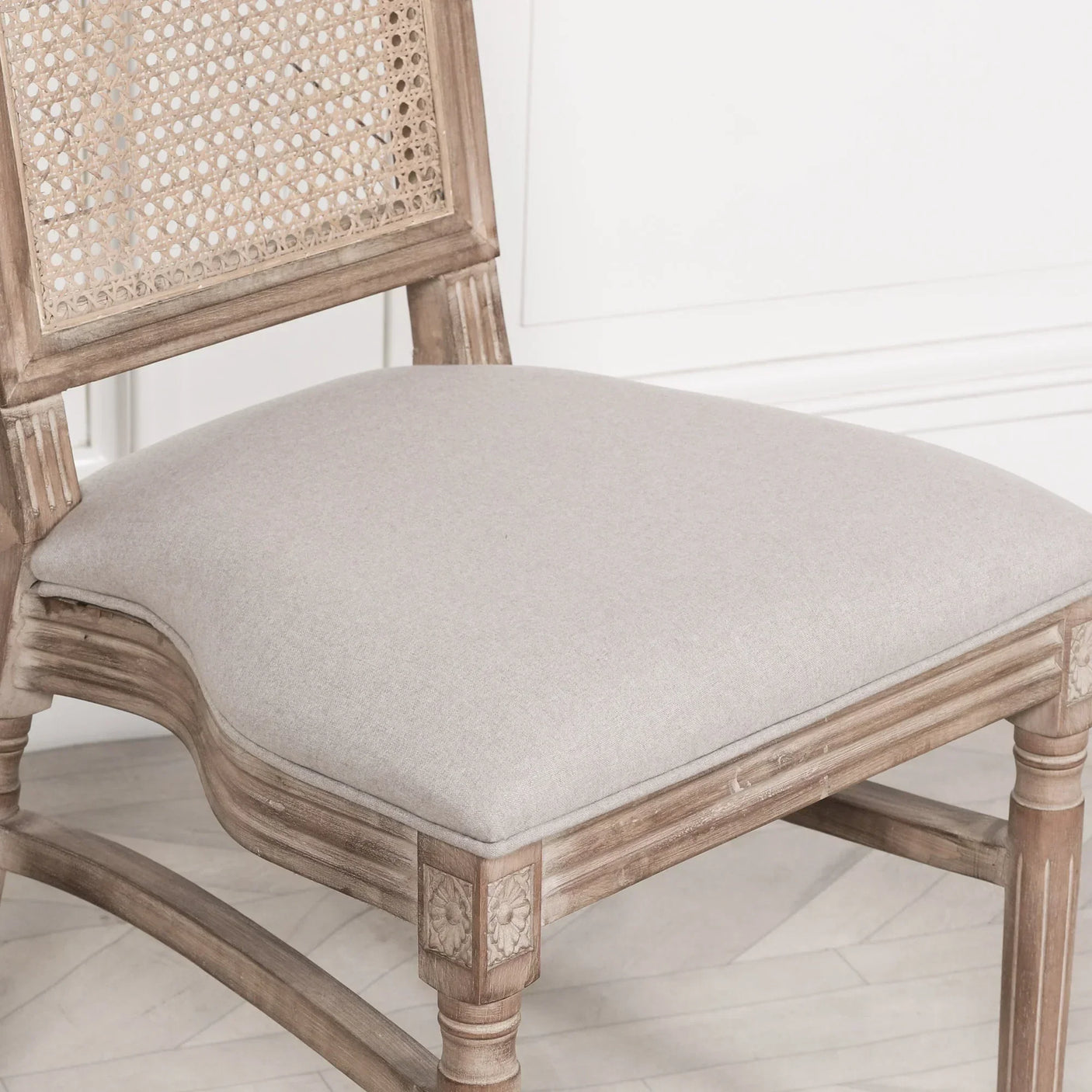 Oak dining chair with cane backrest and upholstered seat in light beige fabric