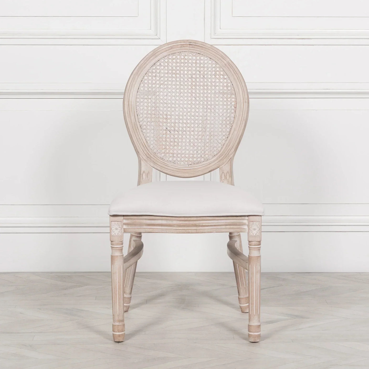 Light wood dining chair with oval cane backrest and upholstered seat, front view