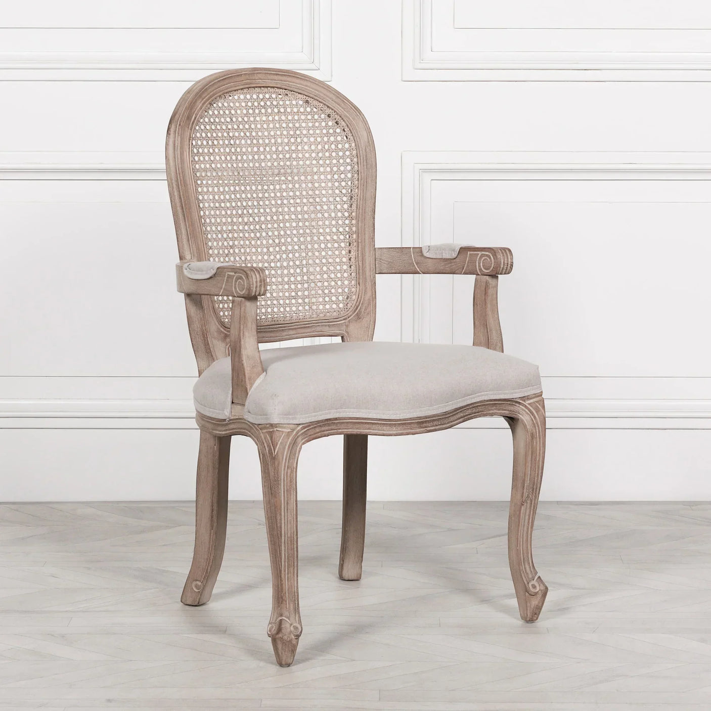 Wooden dining chair with cane back, upholstered seat and carved armrests