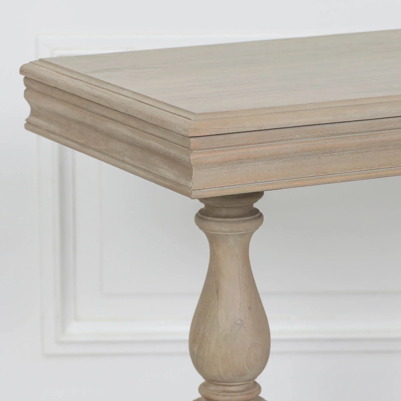 Oak dining table corner with turned leg and light wood finish