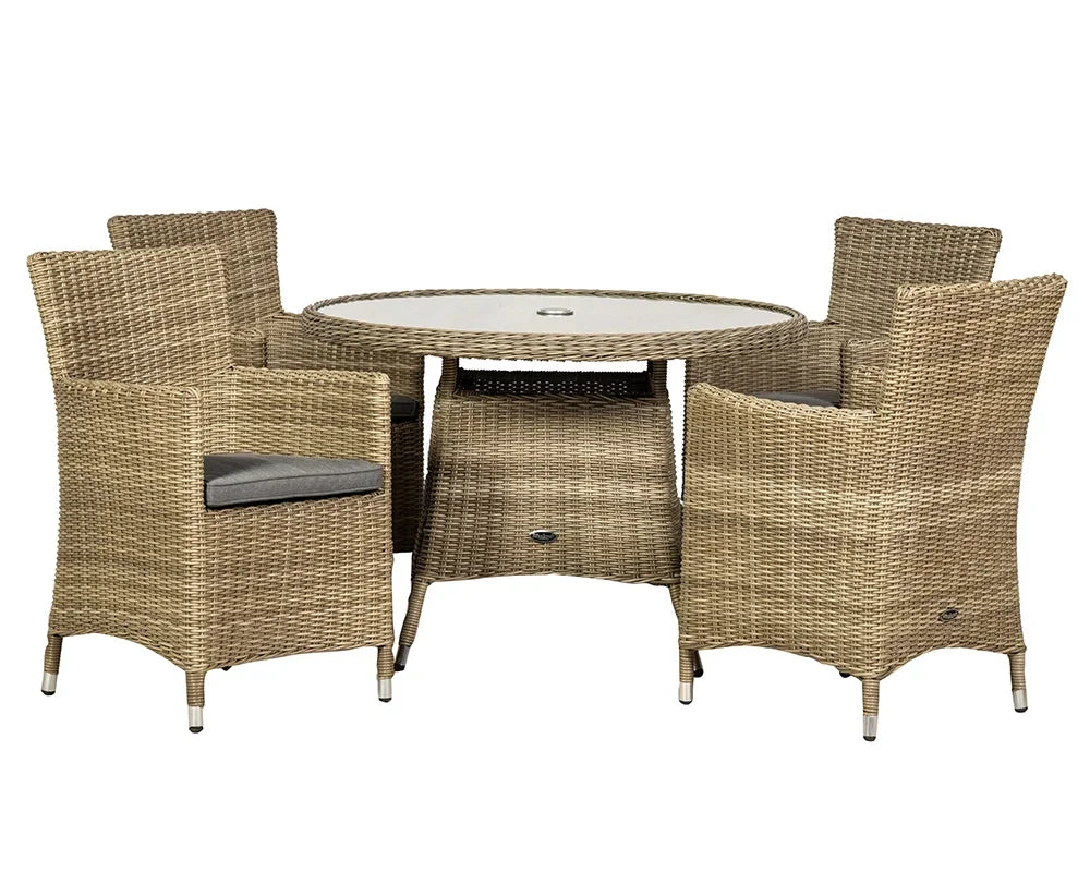 Rattan garden dining set with round glass table and four cushioned armchairs