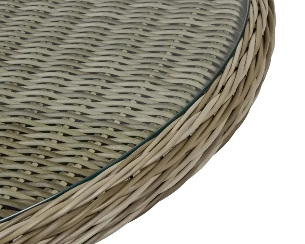 Closeup of rattan garden table with tempered glass top showing woven detail