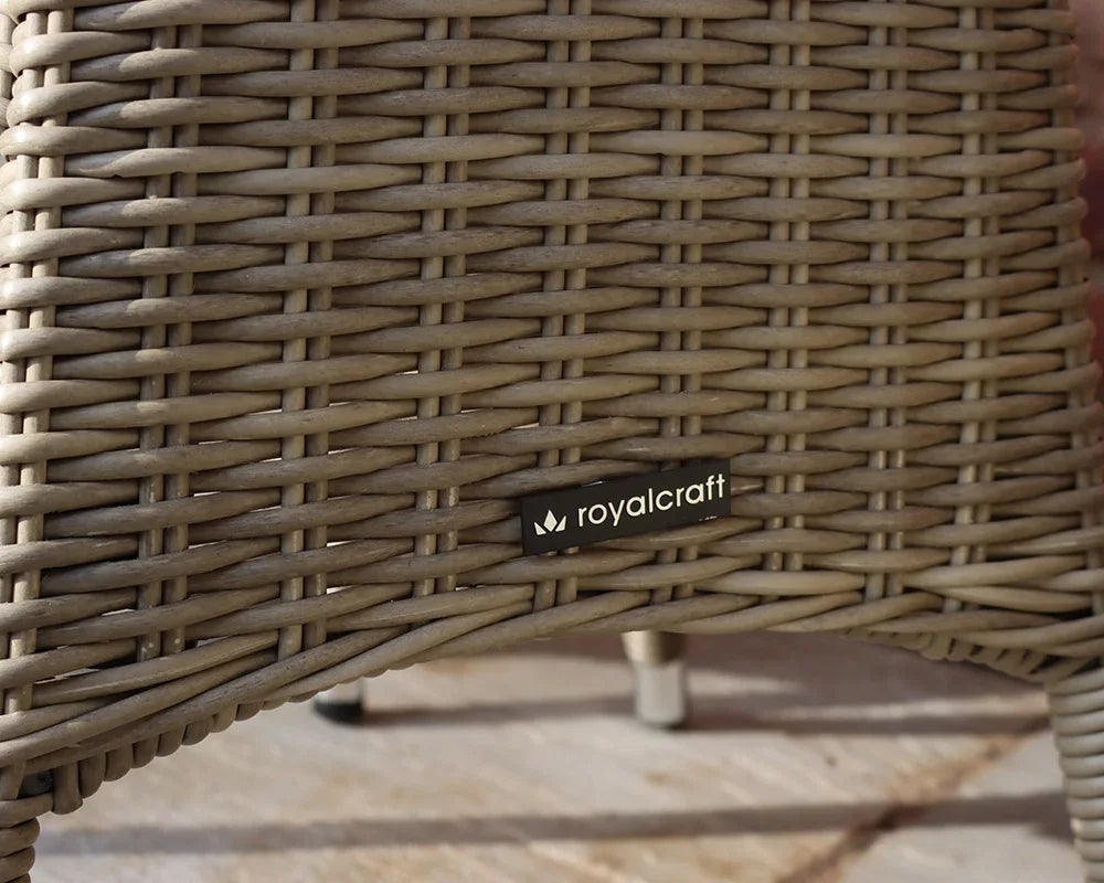Close view of brown rattan furniture leg with Royalcraft label and metal foot