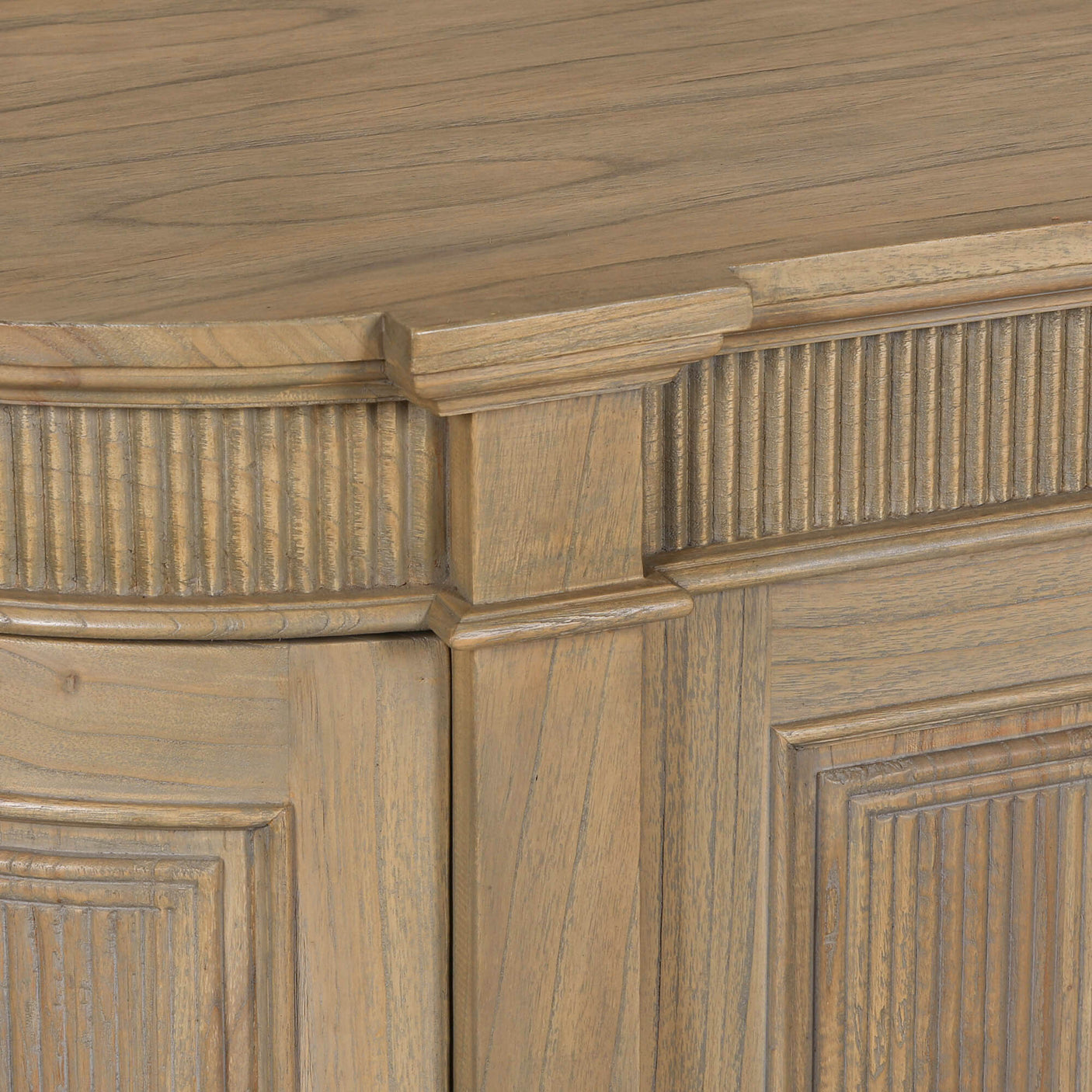 Close-up of a rustic wooden buffet sideboard featuring fluted detailing and a smooth finish.