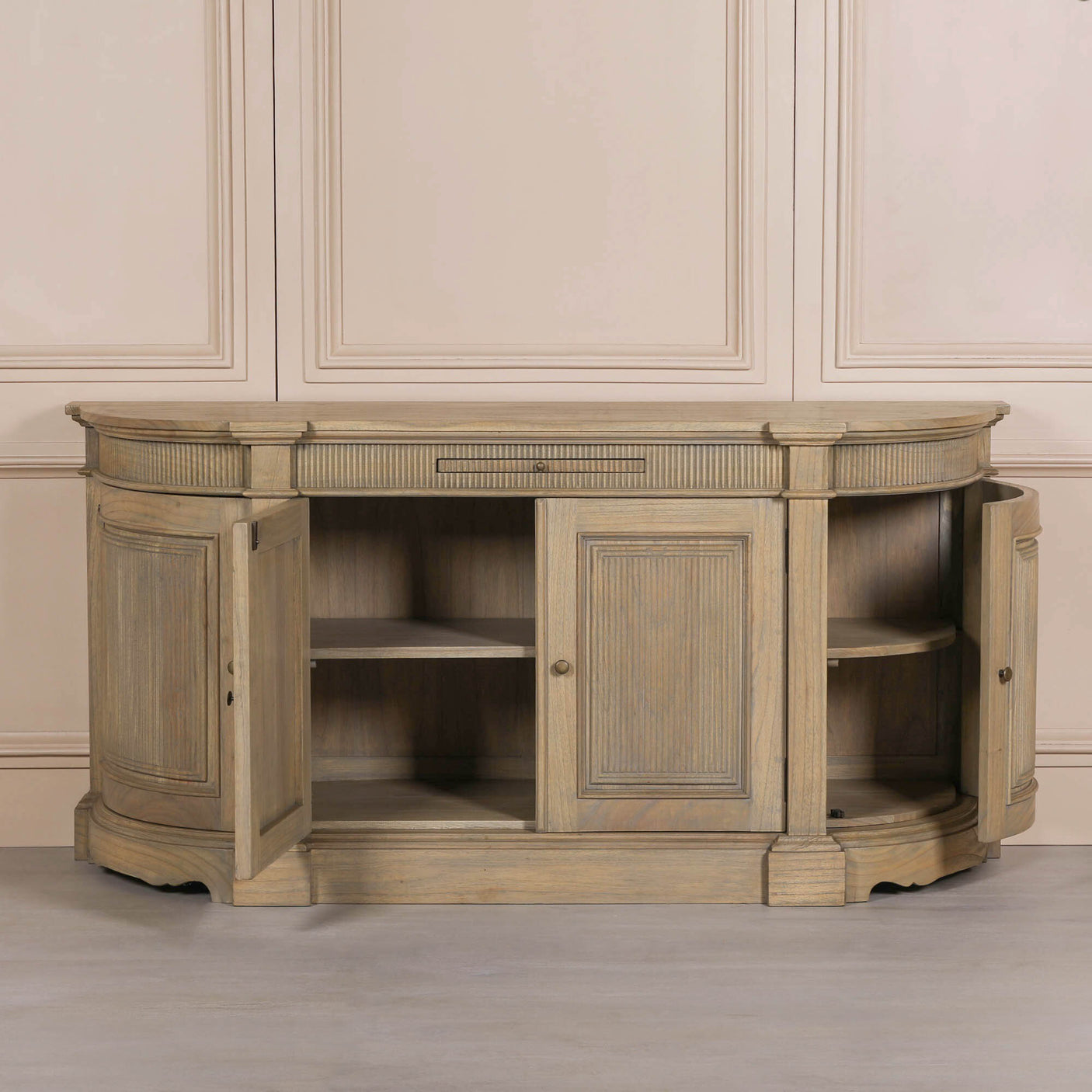 Rustic wooden buffet sideboard with fluted detailing and curved edges, featuring two doors and open shelving.