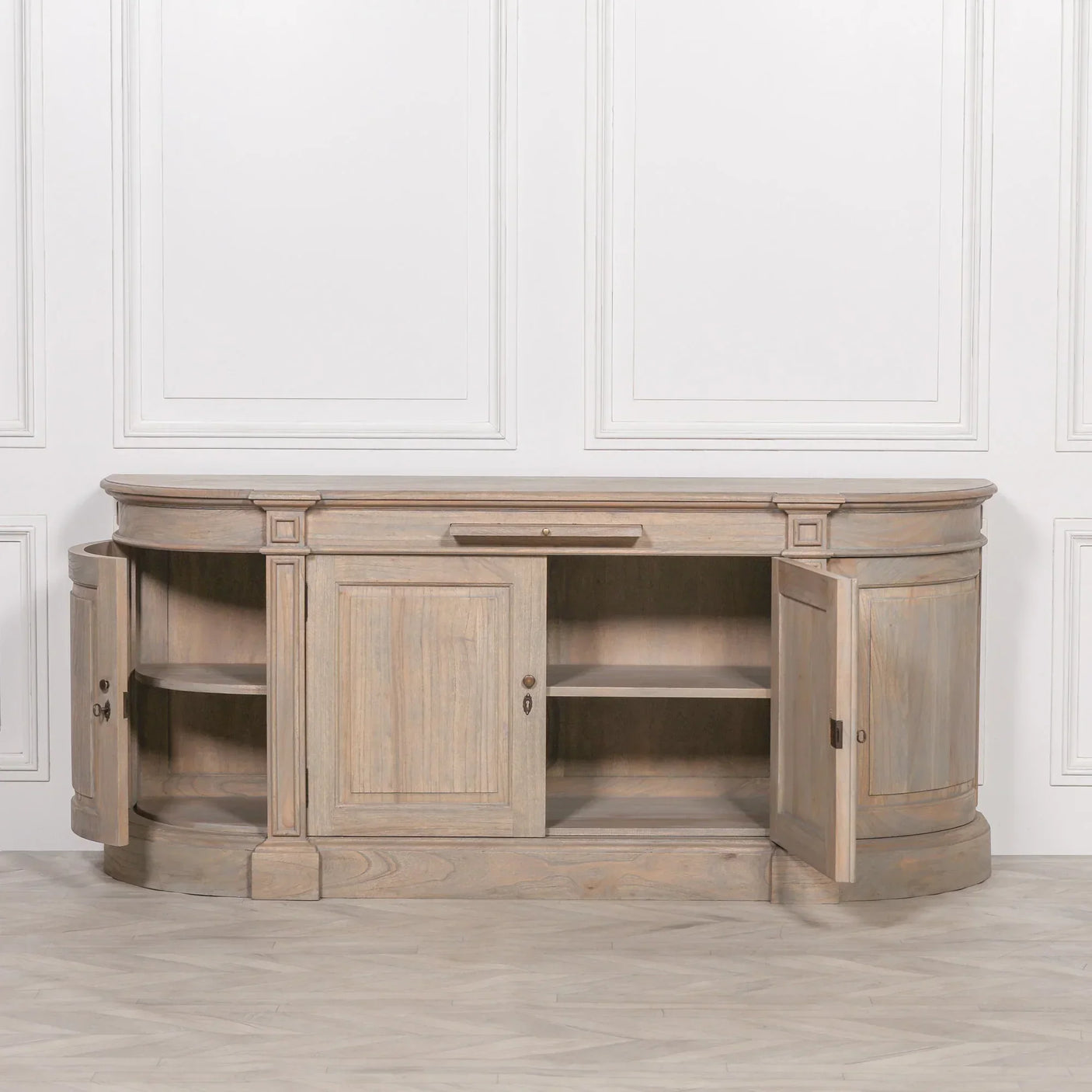 Light oak sideboard with open storage shelves and curved end cabinets against white wall