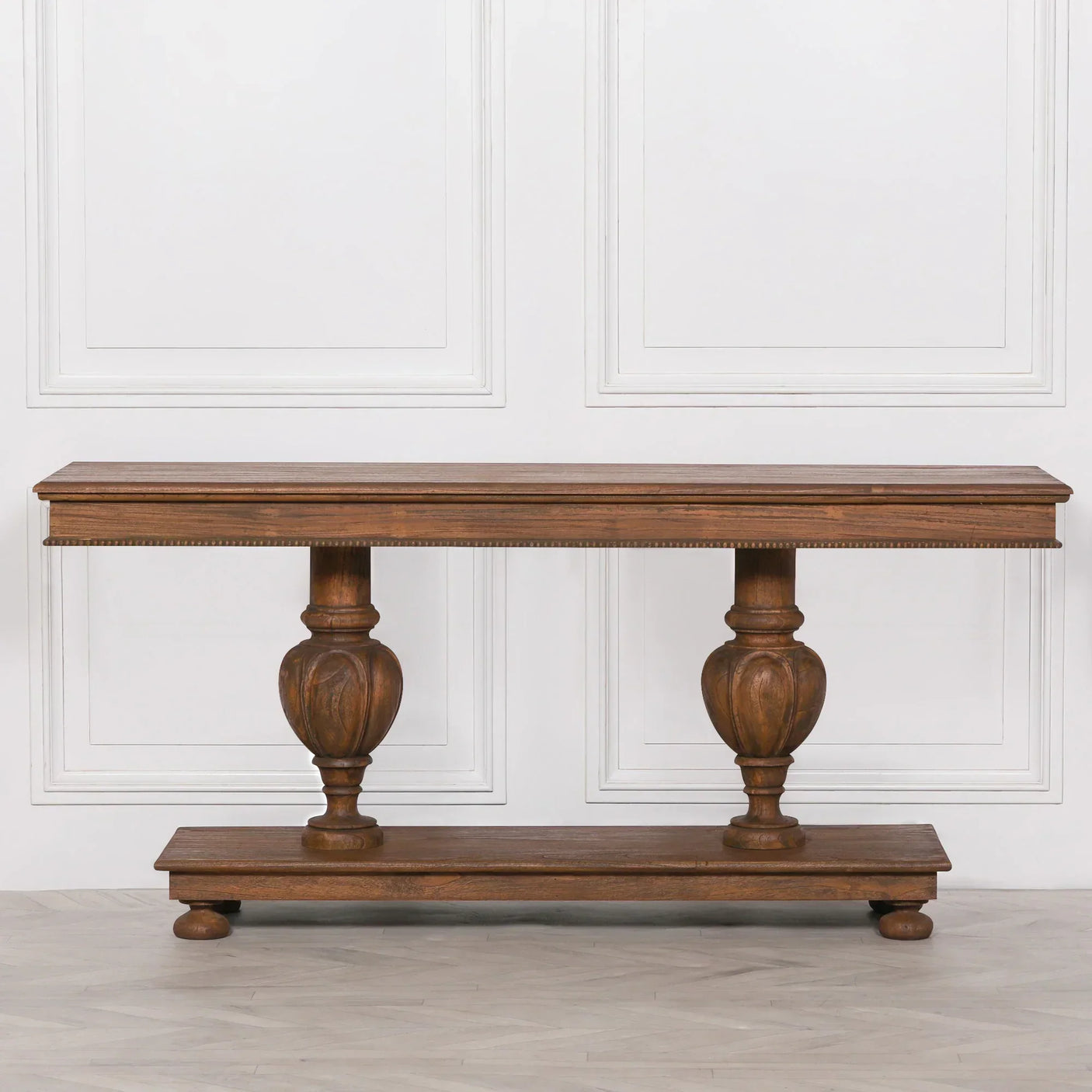 Solid wood console table with carved pedestal legs and rectangular top, front view
