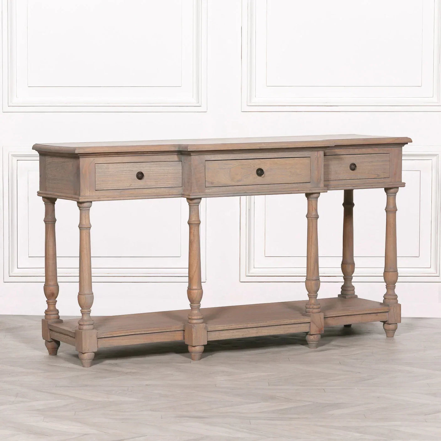 Wooden console table with three drawers and lower shelf, turned legs, light oak finish
