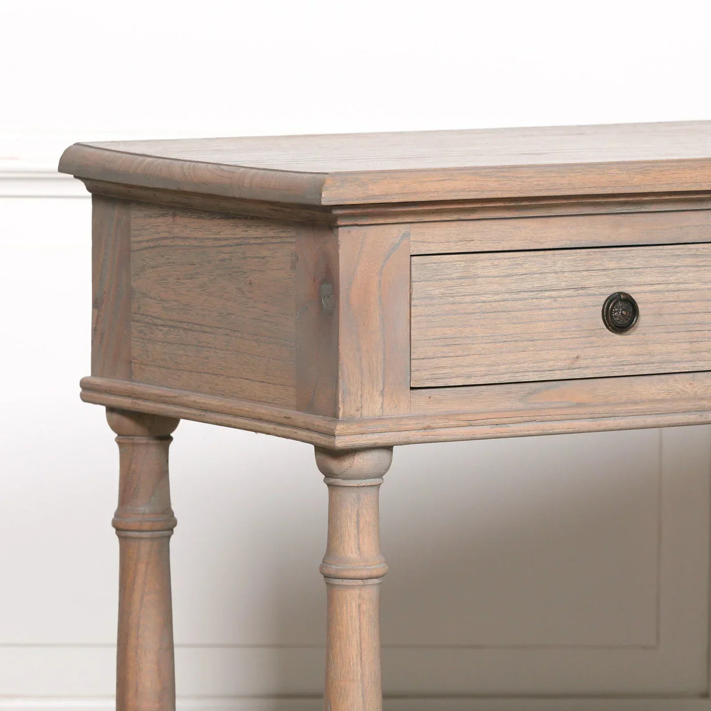 Rustic wood console table with single drawer and turned legs, close-up side view