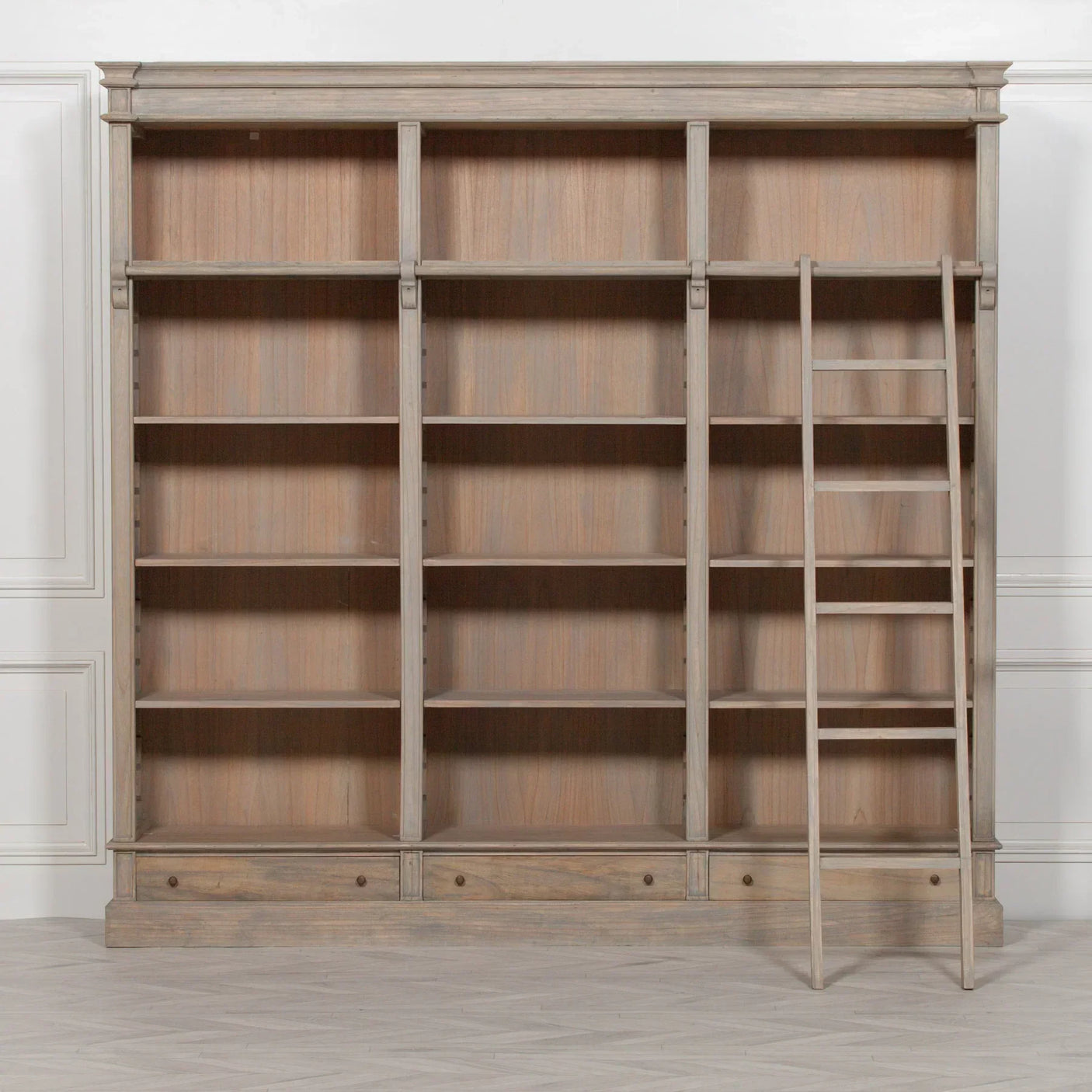 Large wooden bookcase with adjustable shelves and matching library ladder