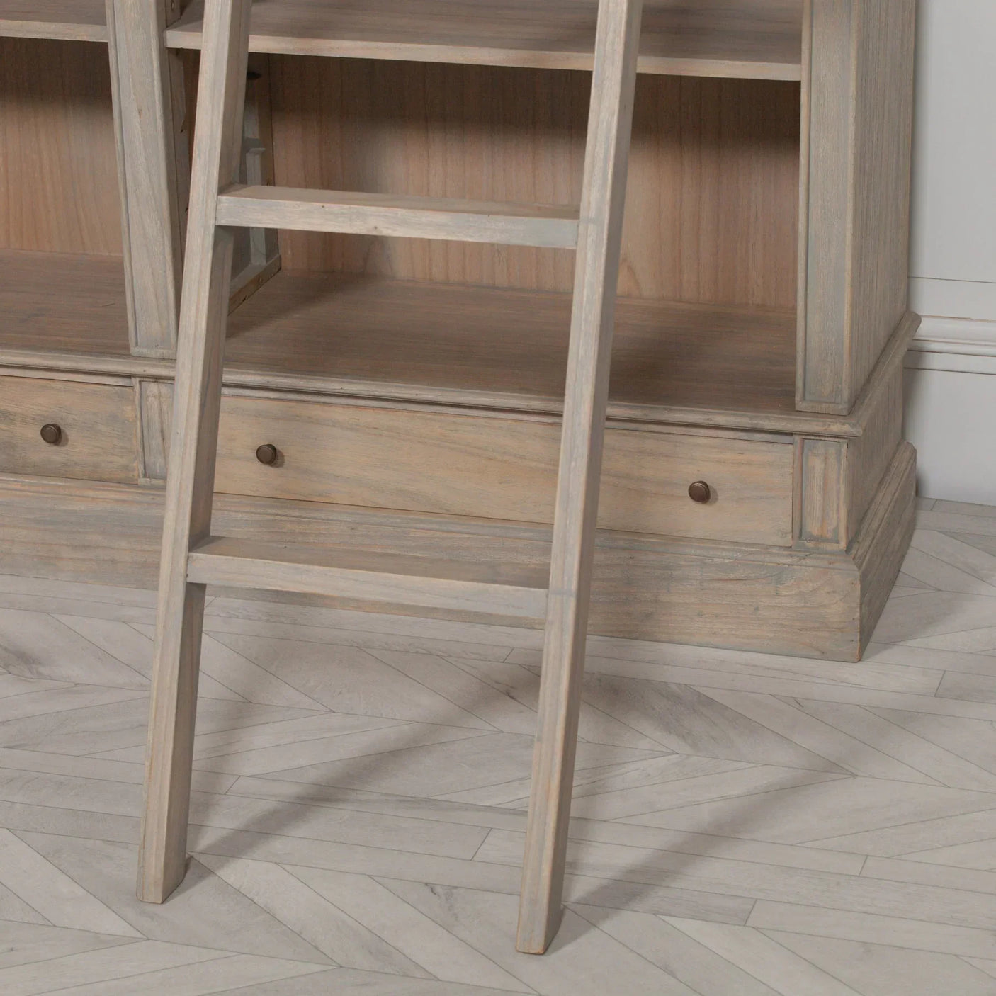 Light wood bookcase with shelving, drawers and leaning library ladder