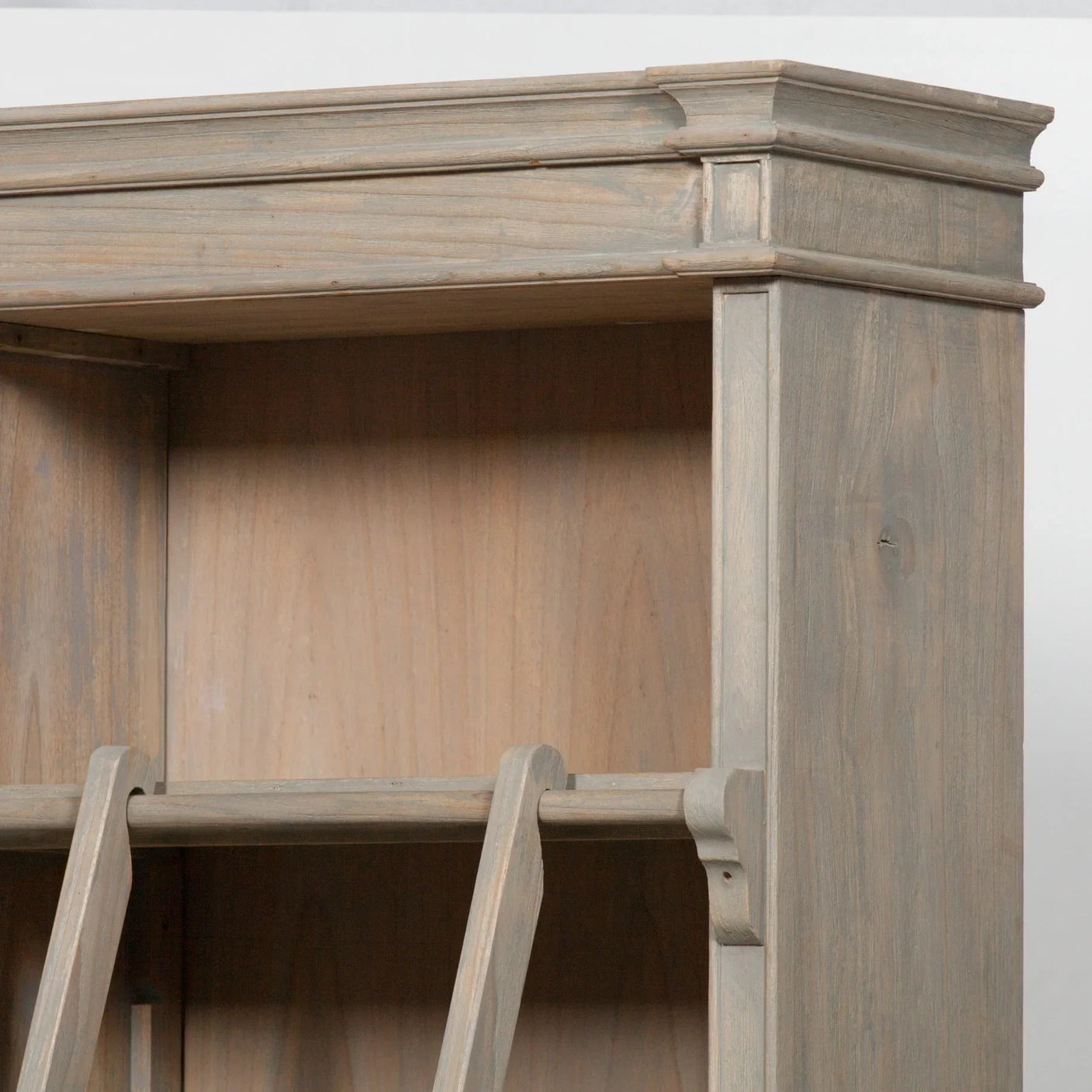 Weathered wood bookcase with open shelf and angled support detail, close-up corner view