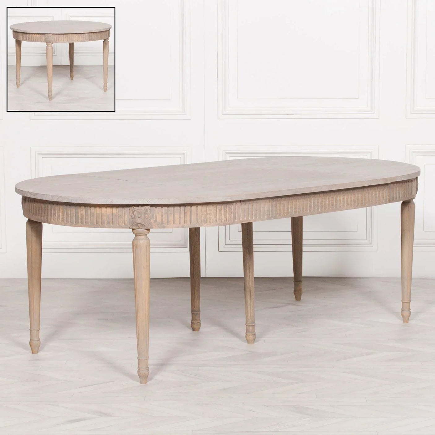 Oval wood dining table with carved detailing and tapered legs, extendable with insert panel